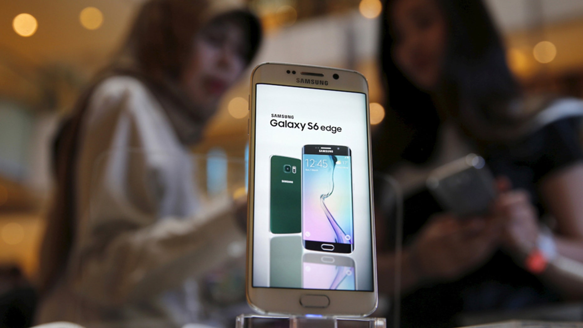 File photo - A Samsung Galaxy S6 edge is pictured while a salesperson (R) talks to a customer, as the Galaxy S6 and Galaxy S6 Edge go on sale to the public, at the Grand Indonesia mall in Jakarta, Indonesia, May 8, 2015.