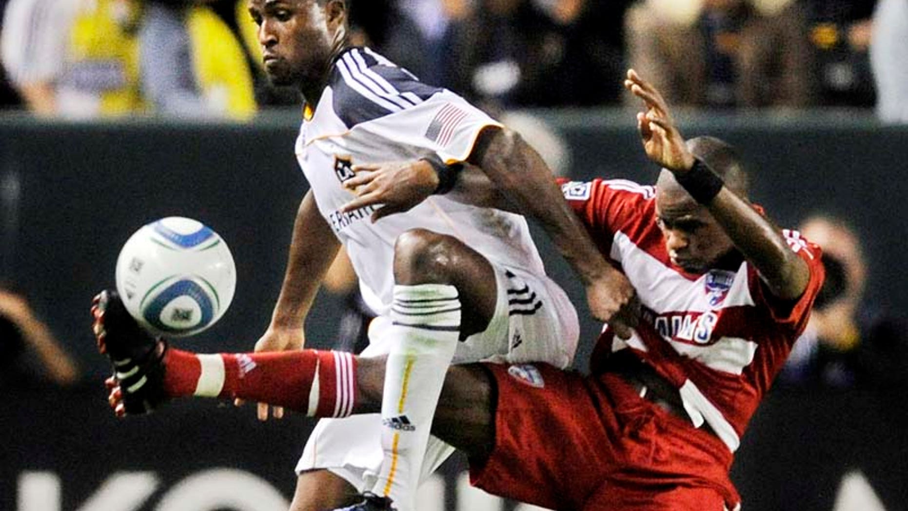Los Angeles Galaxy forward Edson Buddle, left, and FC Dallas defender Jackson Goncalves battle for the ball during the first half of their MLS Western Conference Final playoff match, Sunday, Nov. 14, 2010, in Carson, Calif. (AP Photo/Mark J. Terrill)