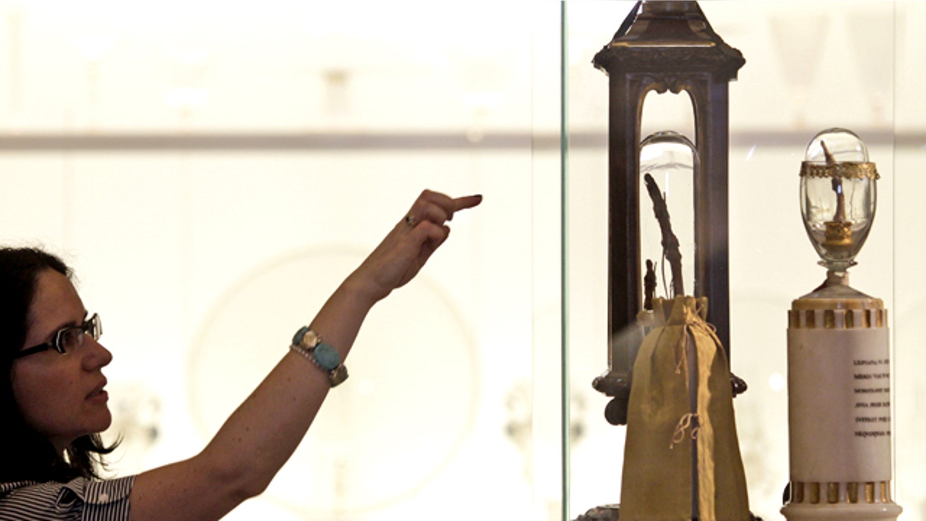 A woman looks at two fingers of Italian 17th century astronomer Galileo Galilei on display at the newly reopened Galileo Museum of Science, in Florence, Tuesday, June 8, 2010.