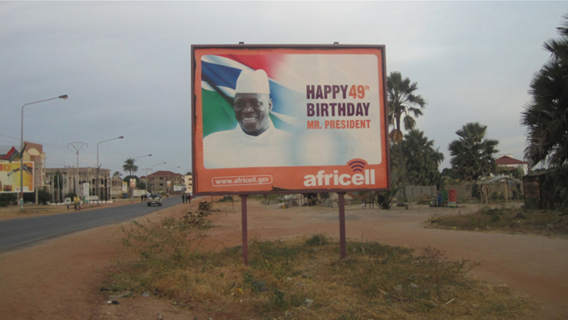 Dec. 31, 2014: A giant billboard of Gambia President Yahya Jammeh sits on an empty street during rush hour in Banjul. Two men have been charged in the United States with conspiring to help overthrow the Gambian government last week. (AP Photo)