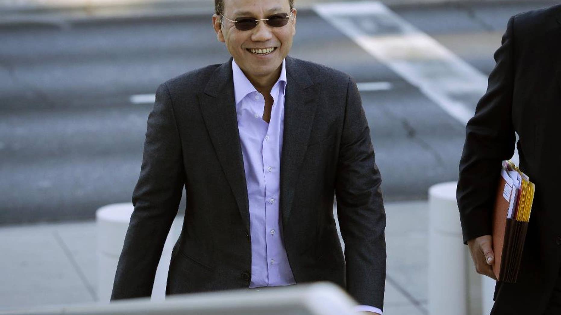 FILE - In this Nov. 6, 2014 file photo, Wei Seng Phua walks into federal court in Las Vegas. Phua, his son Darren Wai Kit Phua, and four others were arrested in July after federal agents raided three high-roller villas at Caesars Palace in Las Vegas. Five defendants are poised to take plea deals. That'll leave Phua and his son, to face trial on charges including operating an illegal gambling business during the World Cup soccer tournament. (AP Photo/John Locher,File)