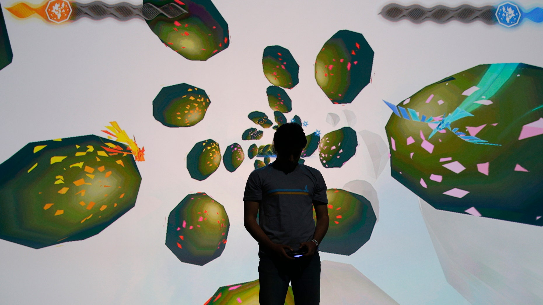 June 9, 2014: A gamer plays the "Entwined" video game during Sony's PlayStation press event at the Electronic Entertainment Expo on Monday, in Los Angeles. Sony is bringing its PlayStation TV video- and game-streaming device to North America and Europe this fall.