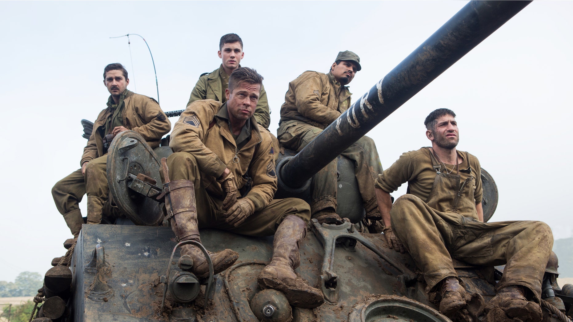 This photo released by Sony Pictures Entertainment shows, from left, Shia LaBeouf as Boyd "Bible" Swan, Logan Lerman as Norman, Brad Pitt as Sgt. Don âWardaddyâ Collier, Michael Pena as Trini "Gordo" Garcia, and Jon Bernthal as Grady "Coon-Ass" Travis, in Columbia Pictures' "Fury." Before the World War II tank drama reaches theaters Oct. 17, gamers can make like Pitt's character and steer a virtual rendition of the M4A3E8 Sherman tank he commands in the film in the game "World of Tanks." It's the latest example of a likeminded movie and game aligning to hype each other, and it marks the first Hollywood pact for the popular online tank combat title. (AP Photo/Sony Pictures Entertainment, Giles Keyte)