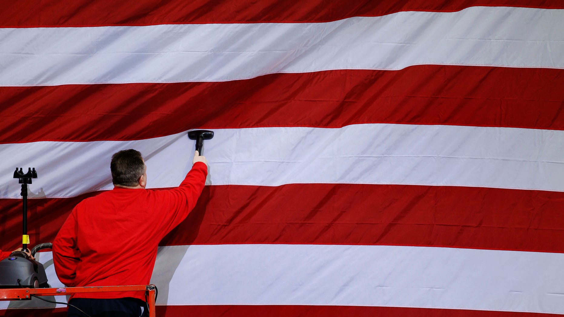 A workman steams a U.S. flag in preparation for a planned visit by President Barack Obama Wednesday, April 6, 2011, at wind turbine manufacture Gamesa Technology Corporation in Fairless Hills, Pa. (AP)