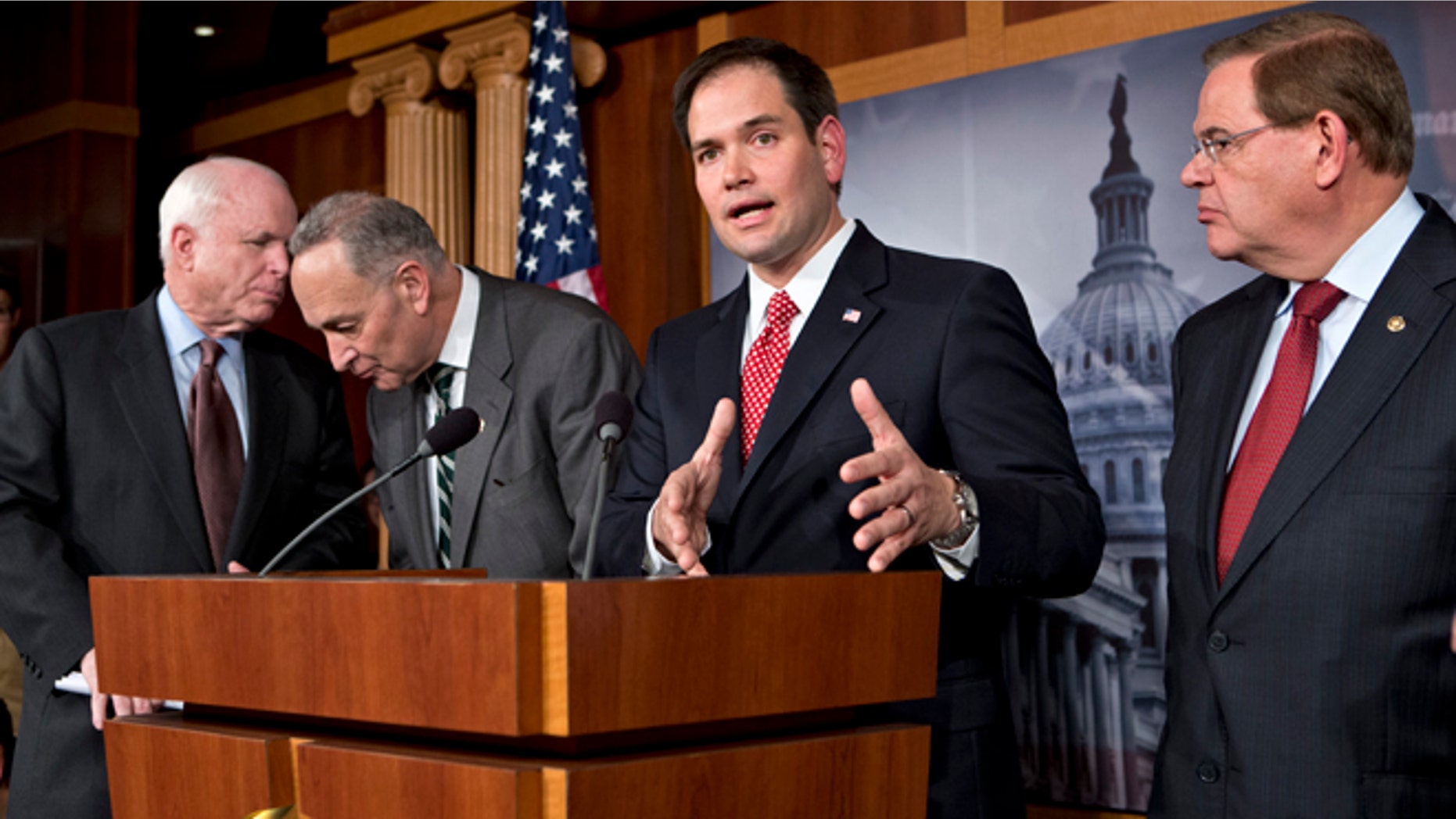 FILE â In this Jan. 28, 2013, file photo Sen. Marco Rubio, R-Fla., center, speaks at a Capitol Hill news conference on immigration legislation with a members of a bipartisan group of leading senators, including, from left, Sen. John McCain, R-Ariz., Sen. Chuck Schumer, D-N.Y. and Sen. Robert Menendez, D-N.J., in Washington. After months of arduous closed-door negotiations, the âGang of Eightâ senators equally divided between the two parties had no issues left to resolve in person, and no more negotiating sessions were planned. Remaining details were left to aides, who were at work completing drafts of the bill. (AP Photo/J. Scott Applewhite, File)