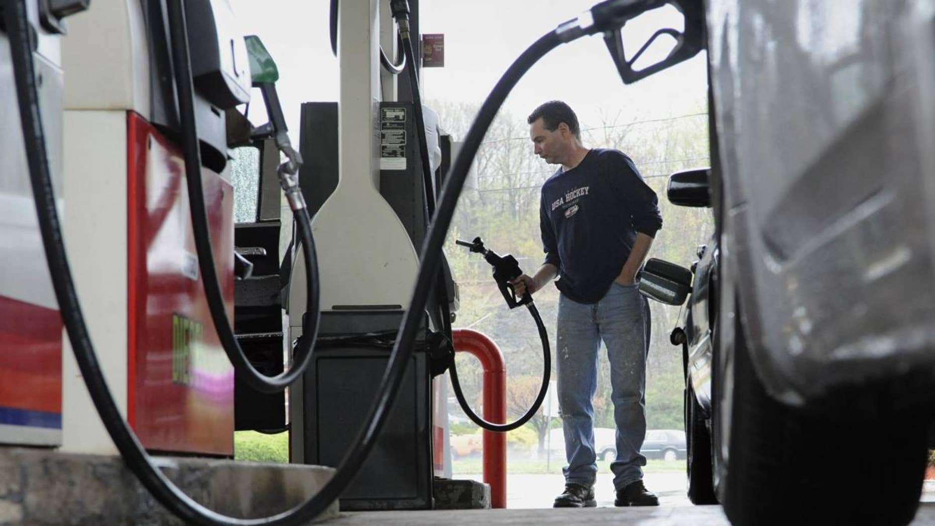 John Magel of Wetherfield pumps gas at a CITGO station in Wethersfield, Conn. (AP Photo/Jessica Hill)