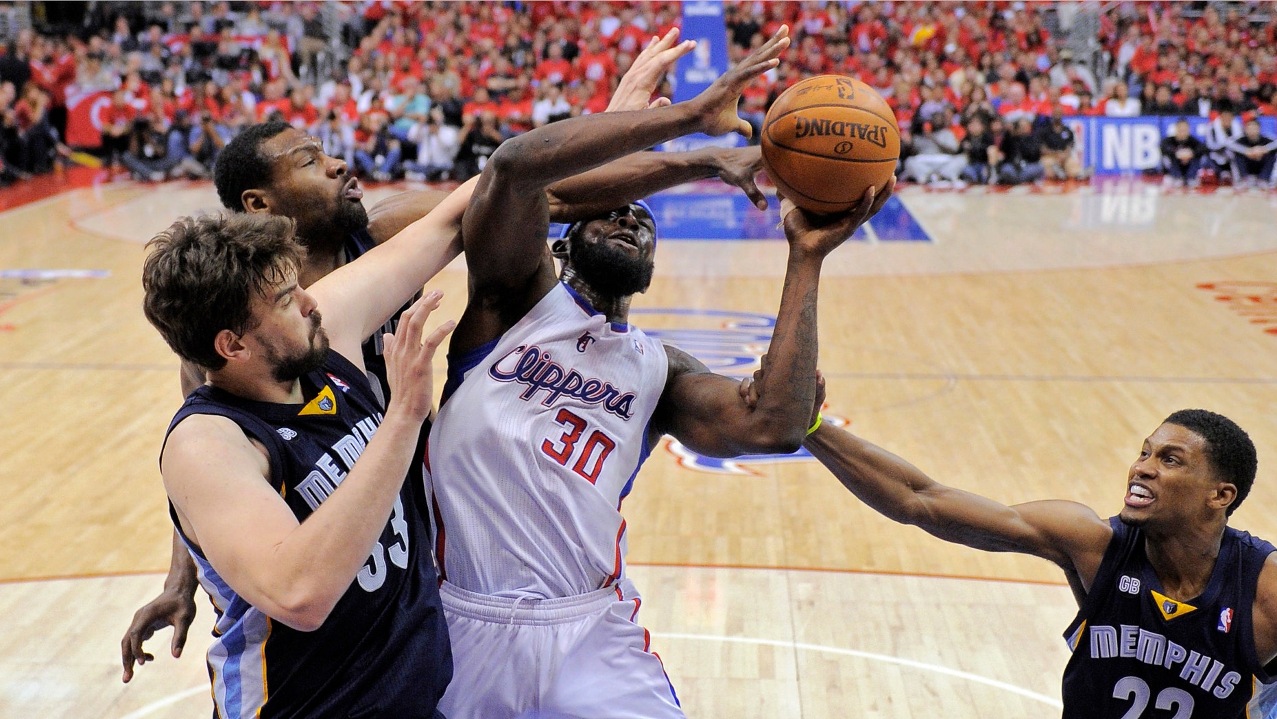 Los Angeles Clippers forward Reggie Evans, second from right, goes up for a shot as Memphis Grizzlies center Marc Gasol, left, of Spain guard Tony Allen, second from left, and forward Rudy Gay defend during the second half in Game 6 in their first-round NBA basketball playoff series, Friday, May 11, 2012, in Los Angeles. The Grizzlies won 90-88. (AP Photo/Mark J. Terrill)