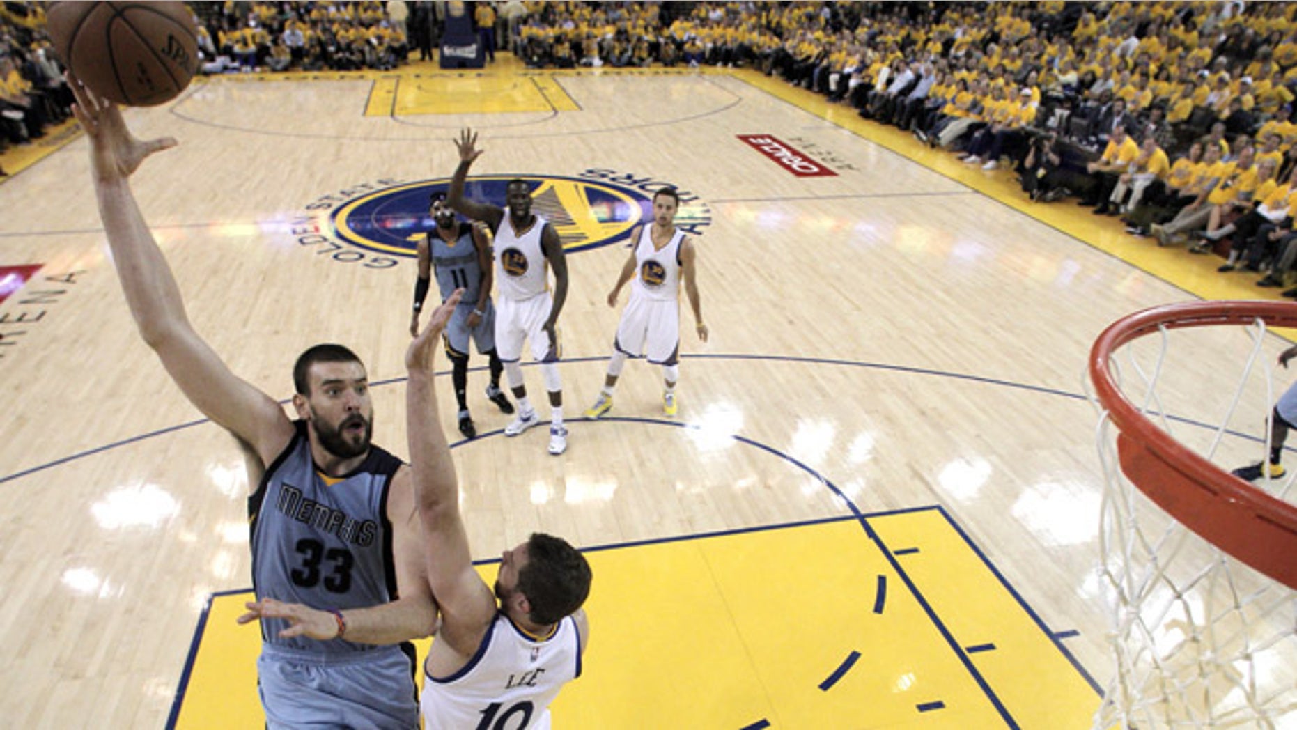 OAKLAND, CA - MAY 13: Marc Gasol #33 of the Memphis Grizzlies shoots over David Lee #10 of the Golden State Warriors during Game Five of the Western Conference Semifinals of the NBA Playoffs at ORACLE Arena on May 13, 2015 in Oakland, California. NOTE TO USER: User expressly acknowledges and agrees that, by downloading and or using this photograph, User is consenting to the terms and conditions of the Getty Images License Agreement. ((Photo by Carlos Gonzalez - Pool /Getty Images)