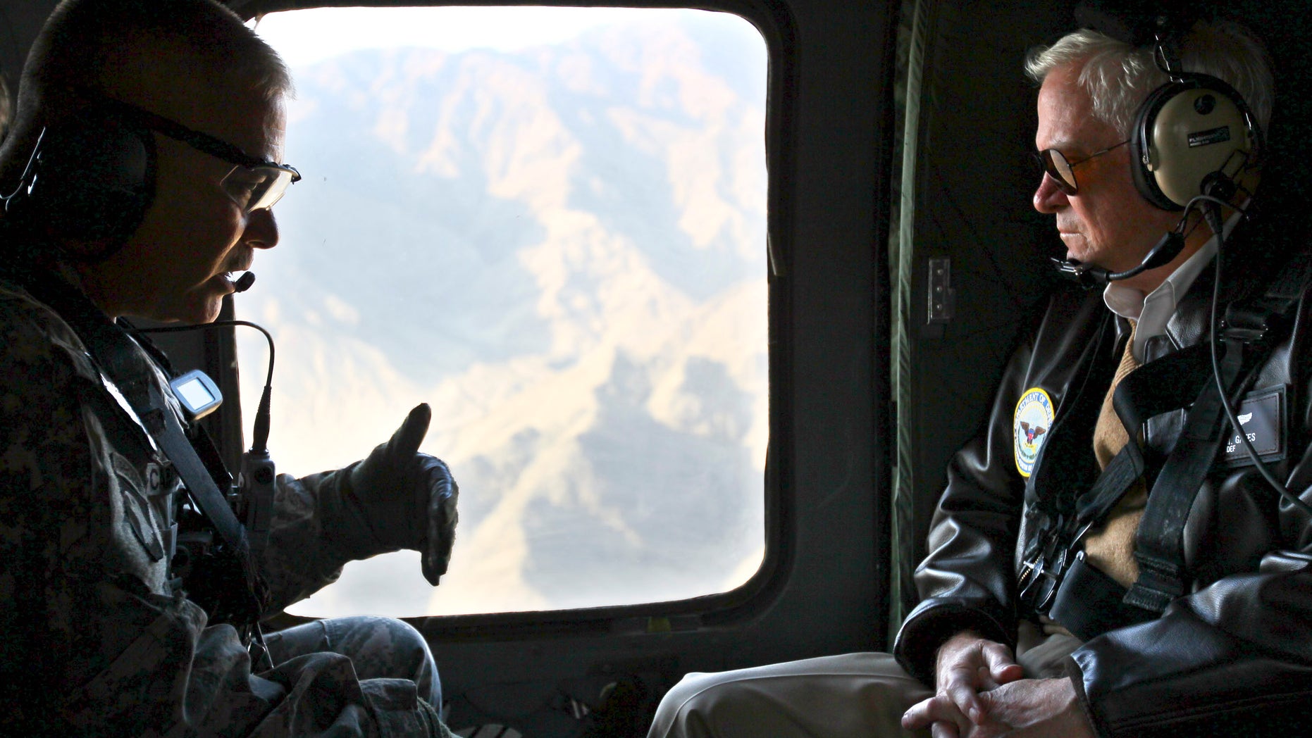Dec. 7: Defense Secretary Robert Gates, right, receives a briefing from Major Gen. John Campbell, left, as they fly aboard a helicopter over Kunar Province, Afghanistan. The U.S. and NATO predict heavier fighting this winter.