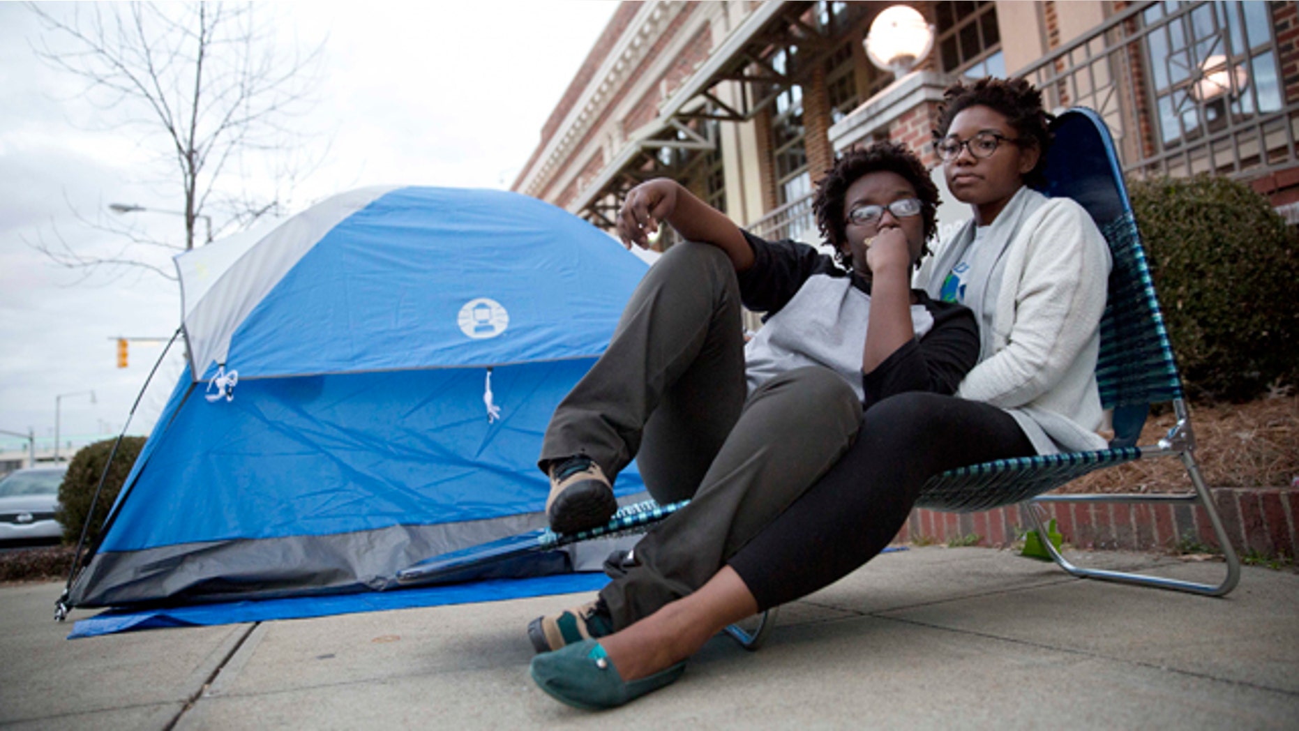 Feb. 8, 2015: Shanté Wolfe, left and Tori Sisson, right, sit near the Montgomery County Courthouse Sunday in Montgomery, Ala. Wolfe and Sisson camped out all night on Sunday to be the first couple to marry in Montgomery on Monday morning. (AP Photo/Brynn Anderson)
