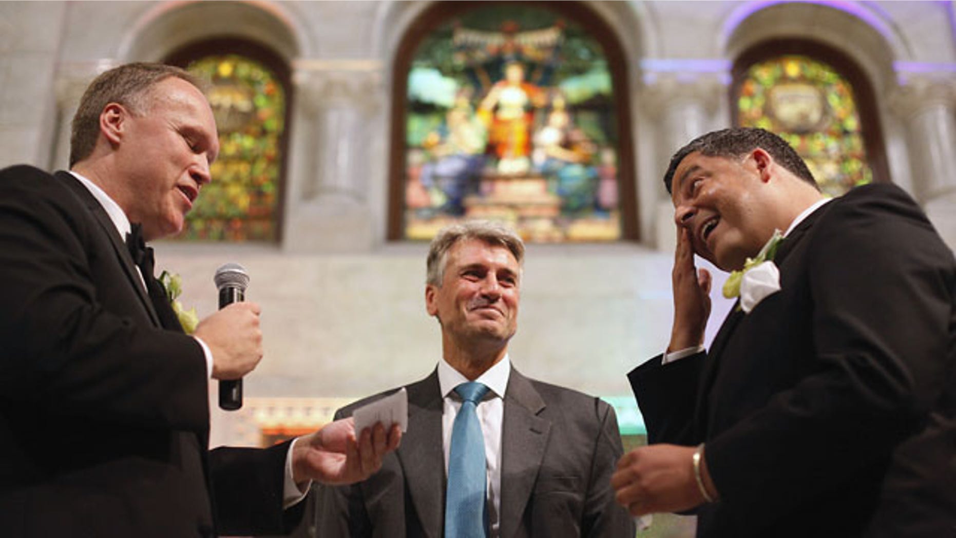 FILE - In this Aug. 1, 2013 file photo, Minneapolis Mayor R.T. Rybak, center, officiates at the wedding of Al Giraud, right, and his partner Jeff Isaacson at the Minneapolis City Hall. They were the first gay couple legally married in Minnesota. (AP Photo)