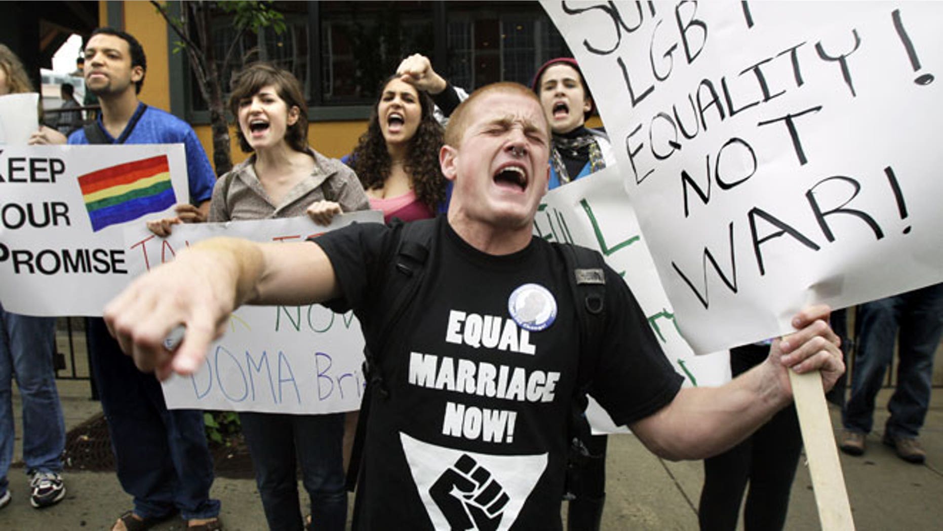 In this June 23, 2009 file photo, Keegan O'Brien of Worcester, Mass., leads chants as members of the LGBT community protest the Defense of Marriage Act outside a Democratic National Committee fundraiser in Boston.