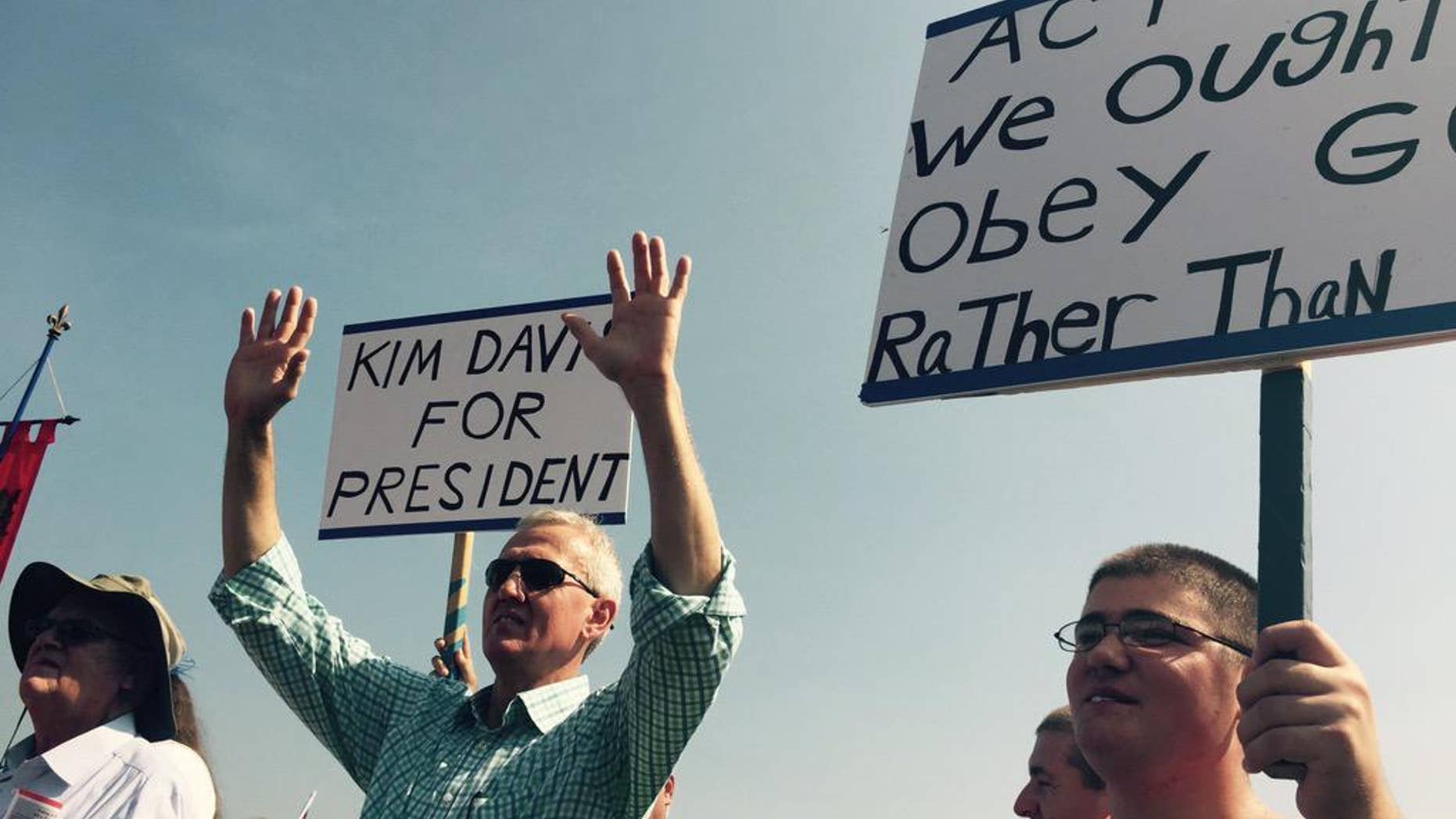 Supporters of Rowan County Clerk Kim Davis hold up signs in support of her, outside the Carter County Detention Center, Saturday, Sept. 5, 2015, in Grayson, Ky. Since the U.S. Supreme Court legalized gay marriage in June, the vast majority of officials have abided by that ruling. However, Davis stopped issuing marriage licenses to any couple, gay or straight, in defiance of a federal court order, and was sent to jail on Thursday. (Joe Gerth/The Courier-Journal via AP)