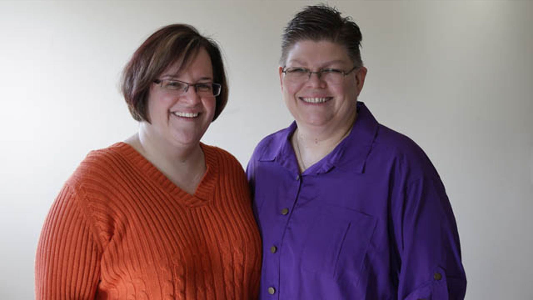 FILE - In this March 5, 2013 file photo, April DeBoer, left, and Jayne Rowse, and pose at their home in Hazel Park, Mich. (AP Photo)
