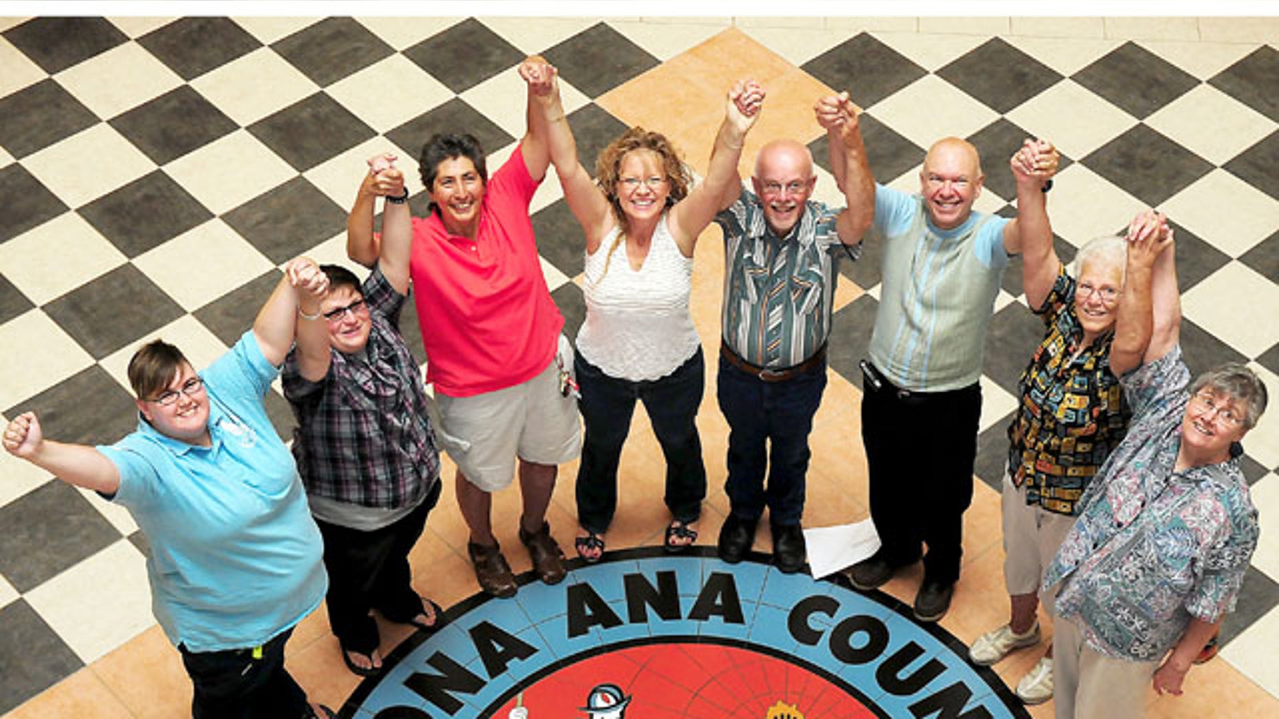 August 22, 2013: Happy newlyweds join hands at the Doña Ana County Government Center after receiving their marriage licenses and wedding in Las Cruces, N.M. The married couples include, from left: Erin Haynes and spouse Cynthia Haynes of Los Lunas, N.M.; Rev. Vangie Chavez and spouse Traci Garcia of Albuquerque, N.M.; Richard Sunman and spouse Thom Hinks of Albuquerque, N.M.; and Judi Schultz and spouse June Damuth of Las Cruces, N.M. (AP Photo/Las Cruces Sun-News, Shari Vialpando-Hill)