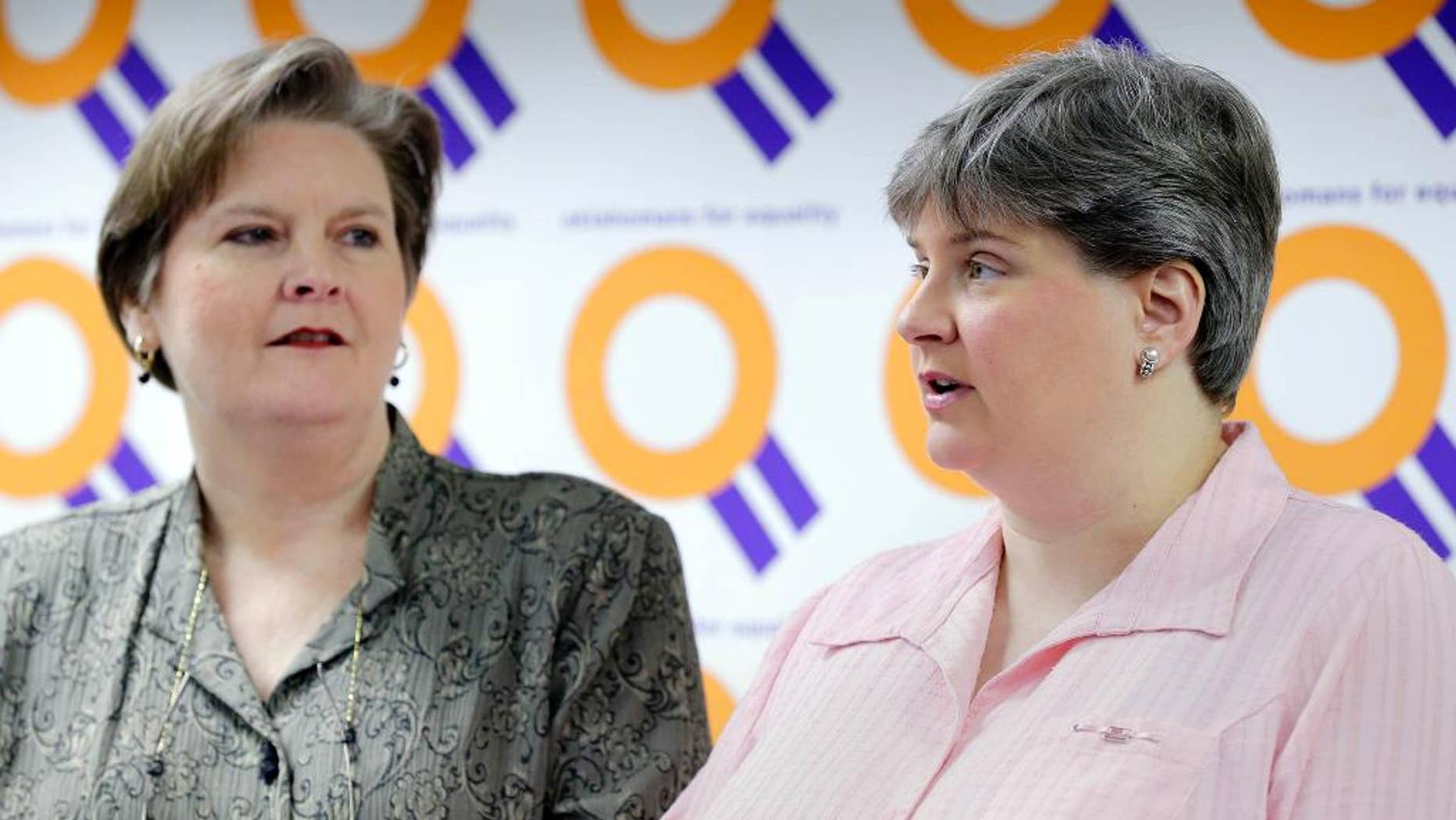 FILE - In this March 17, 2014 file photo, Mary Bishop, left, listens as her partner Sharon Baldwin speaks about the status of appeals in the ongoing Oklahoma same sex marriage fight during a news conference at the Dennis R. Neill Equality Center in Tulsa, Okla. In a brief filed Tuesday, April 1, 2014, lawyers for an Oklahoma clerk who refused to grant a marriage license to Bishop and Baldwin say marriage exists for its procreative potential and that the U.S. Supreme Court agrees. (AP Photo/Tulsa World, Michael Wyke, File) ONLINE OUT; KOTV OUT; KJRH OUT; KTUL OUT; KOKI OUT; KQCW OUT; KDOR OUT; TULSA OUT; TULSA ONLINE OUT
