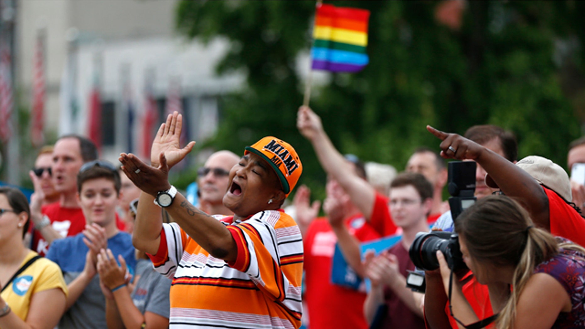 August 5, 2014: Corey Smith of Mt. Healthy, Ohio joined hundreds of others along with the group Why Marriage Matters Ohio at a rally for gay marriage in Lytle Park in Cincinnati. Federal appeals courts soon will hear arguments in gay marriage fights from nine states, part of a slew of cases putting pressure on the U.S. Supreme Court to issue a final verdict. (AP Photo/The Cincinnati Enquirer, Jeff Swinger)