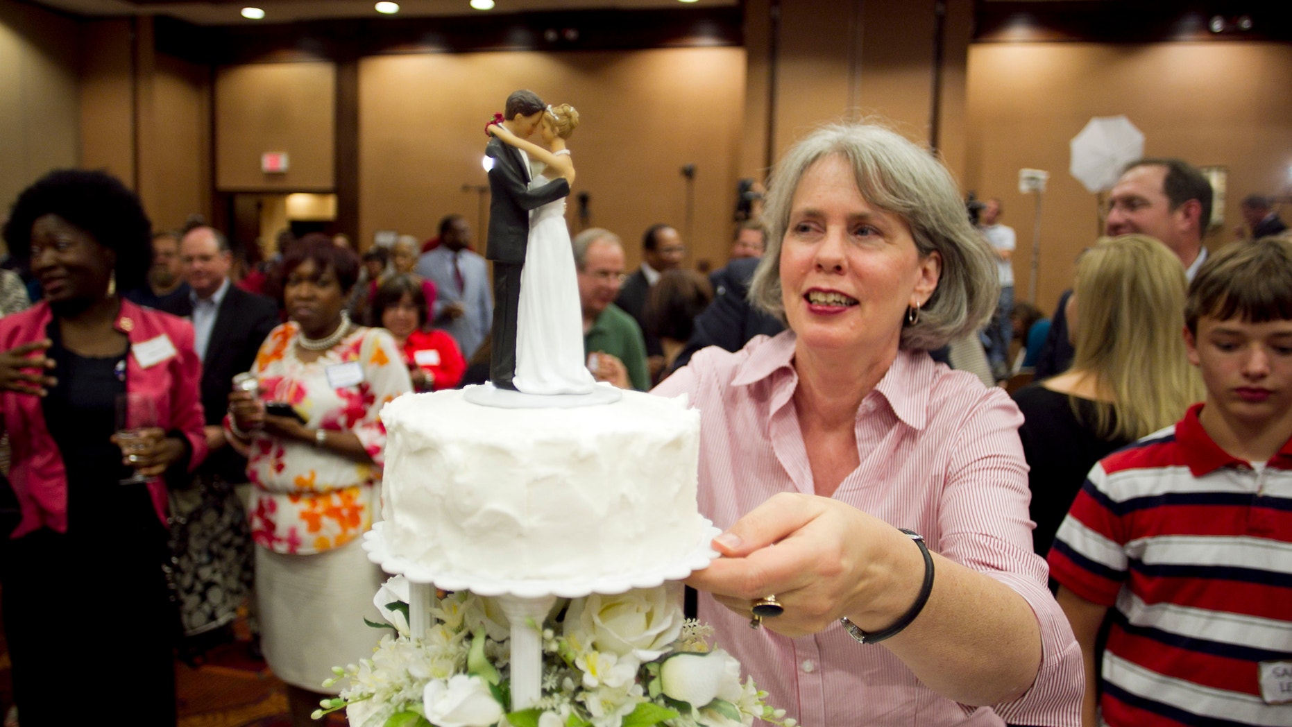 May 8. 2012: Frances Newby prepares to slice a wedding cake to celebrate the passage of Amendment One during an election night party in Raleigh, N.C.