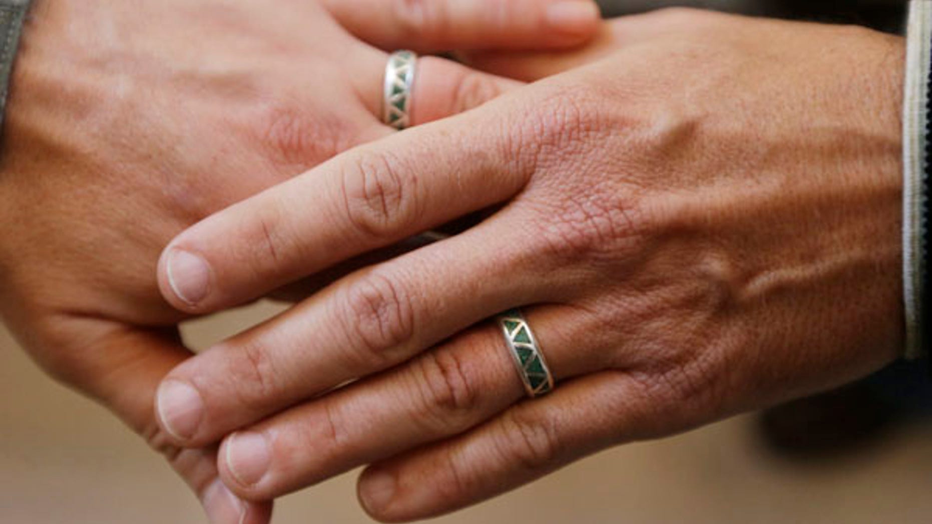 June 29, 2013: Army Capt. Michael Potoczniak, left, and Todd Saunders, of El Cerrito, Calif., show their wedding rings after they exchanged vows at City Hall in San Francisco.