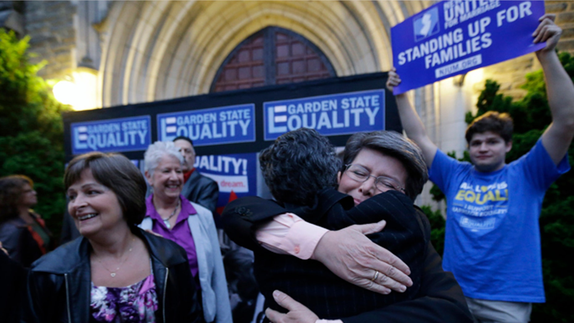 Sept. 27, 2013: Cindy Meneghin, second from right, hugs her attorney Hayley Gorenberg during a rally at Garden State Equality in Montclair, N.J., hours after a Superior Court Judge ruled that New Jersey is unconstitutionally denying federal benefits to gay couples and must allow them to marry.