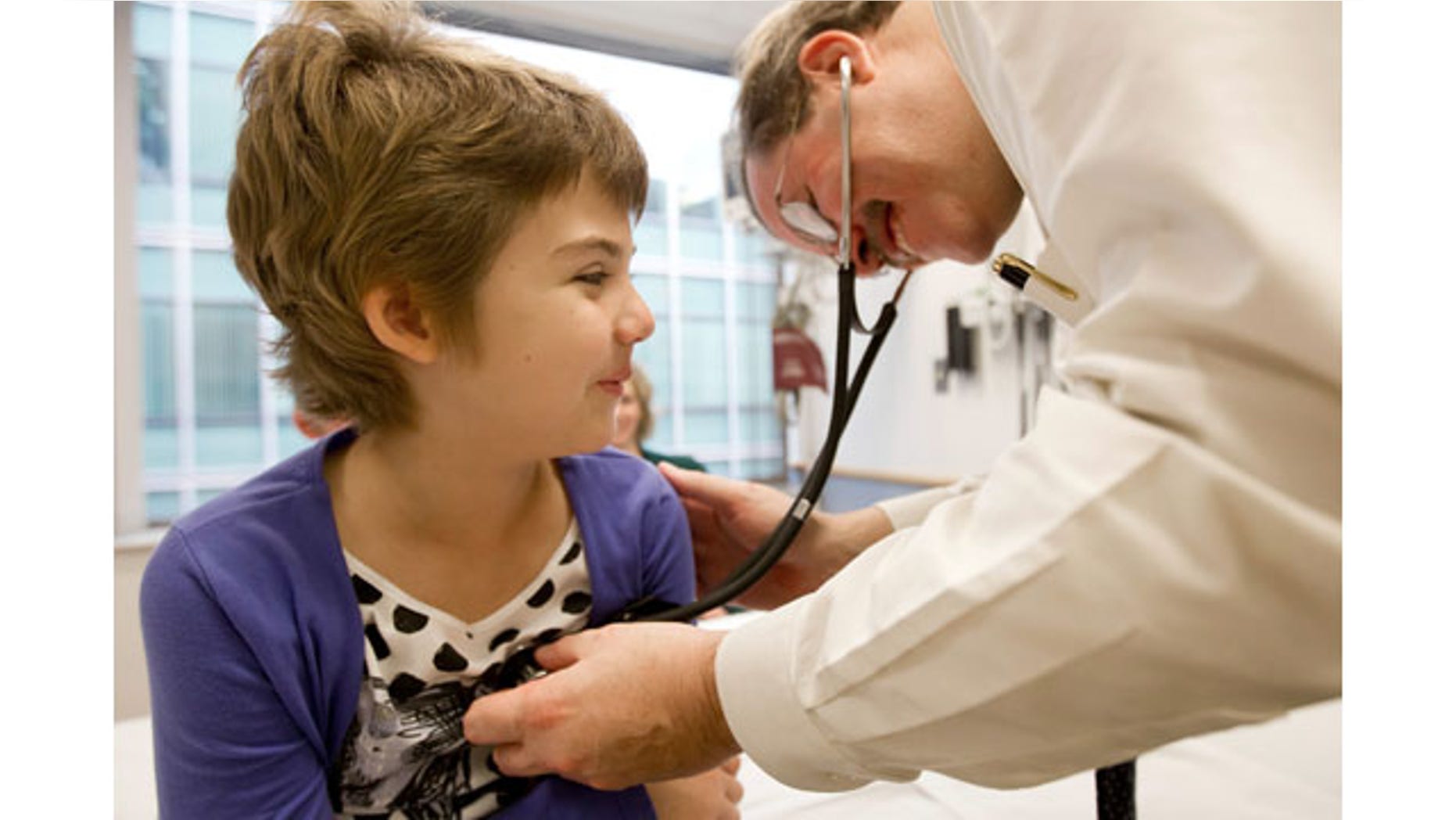 In this October 2012 photo provided by The Children’s Hospital of Philadelphia, Emily Whitehead is checked by pediatric oncologist, Dr. Stephan A. Grupp, at the hospital. In early 2012, she was the first child given gene therapy for acute lymphocytic leukemia and shows no sign of cancer today, nearly 21 months after. (AP Photo/The Children's Hospital of Philadelphia, Ed Cunicelli)