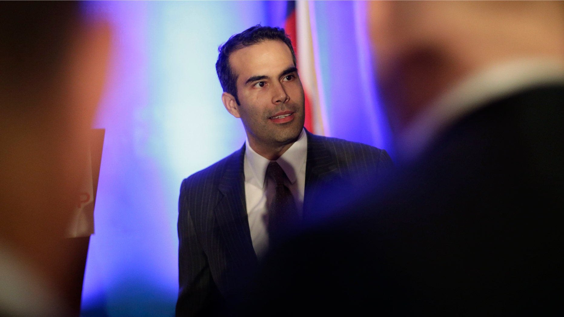 FILE - In this Feb. 26, 2013 file photo, George P. Bush, left, talks to businessmen prior to making the opening statements at the Texas Business Leadership Council in Austin, Texas. Ending months of speculation about what post the grandson of one former U.S. president and nephew of another planned to seek, spokesman Trey Newton told The Associated Press that Bush filed the official paperwork Tuesday, March 12, 2013 to run for land commissioner, a popular stepping stone to higher office.(AP Photo/Eric Gay, File)
