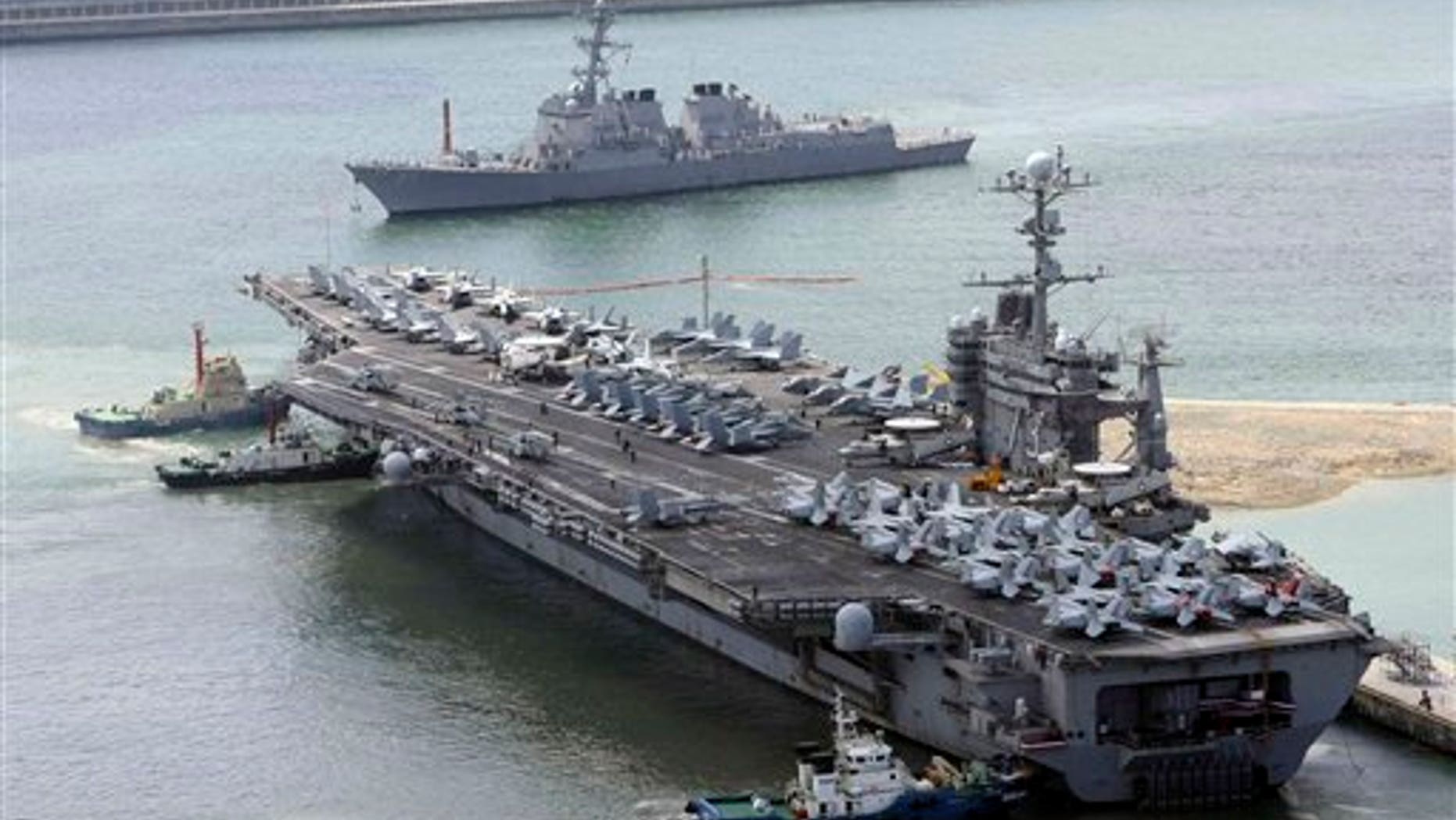 July 21: The massive USS George Washington aircraft carrier is escorted into the Busan port in South Korea for joint military exercises.
