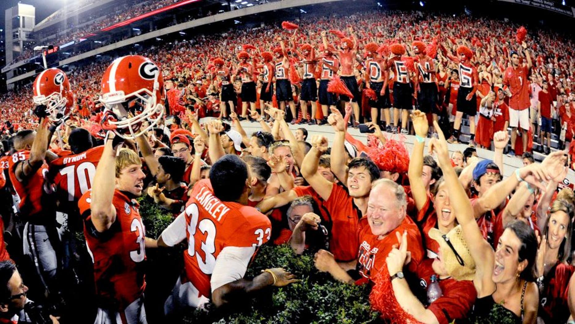 Aug 30, 2014; Athens, GA, USA; Georgia Bulldogs players and fans react after defeating the Clemson Tigers at Sanford Stadium. Georgia defeated Clemson 45-21. Mandatory Credit: Dale Zanine-USA TODAY Sports