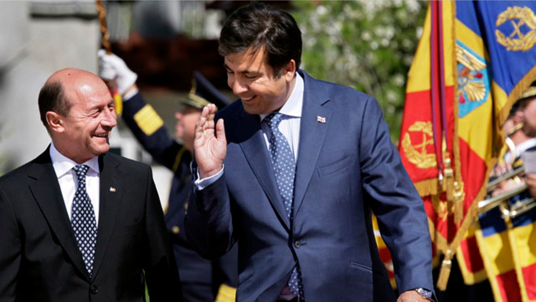 June 2: Georgian President Mikhail Saakashvili and Romanian President Traian Basescu walk past an honor guard during the welcoming ceremony at the Cotroceni Presidential Palace, Bucharest, Romania.