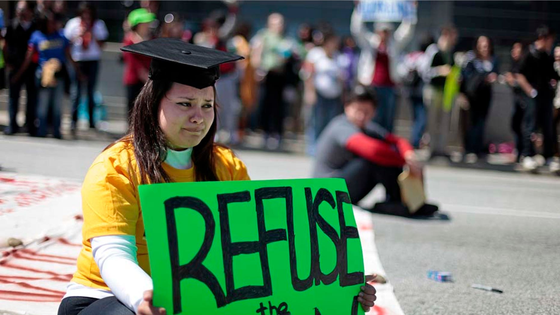 Illegal Immigrant Virdiana Martinez, sheds a tear before being arrested during a protest for rights for higher education for illegal immigrants that blocked traffic Tuesday, April 5, 2011 in Atlanta. (AP Photo/David Goldman)