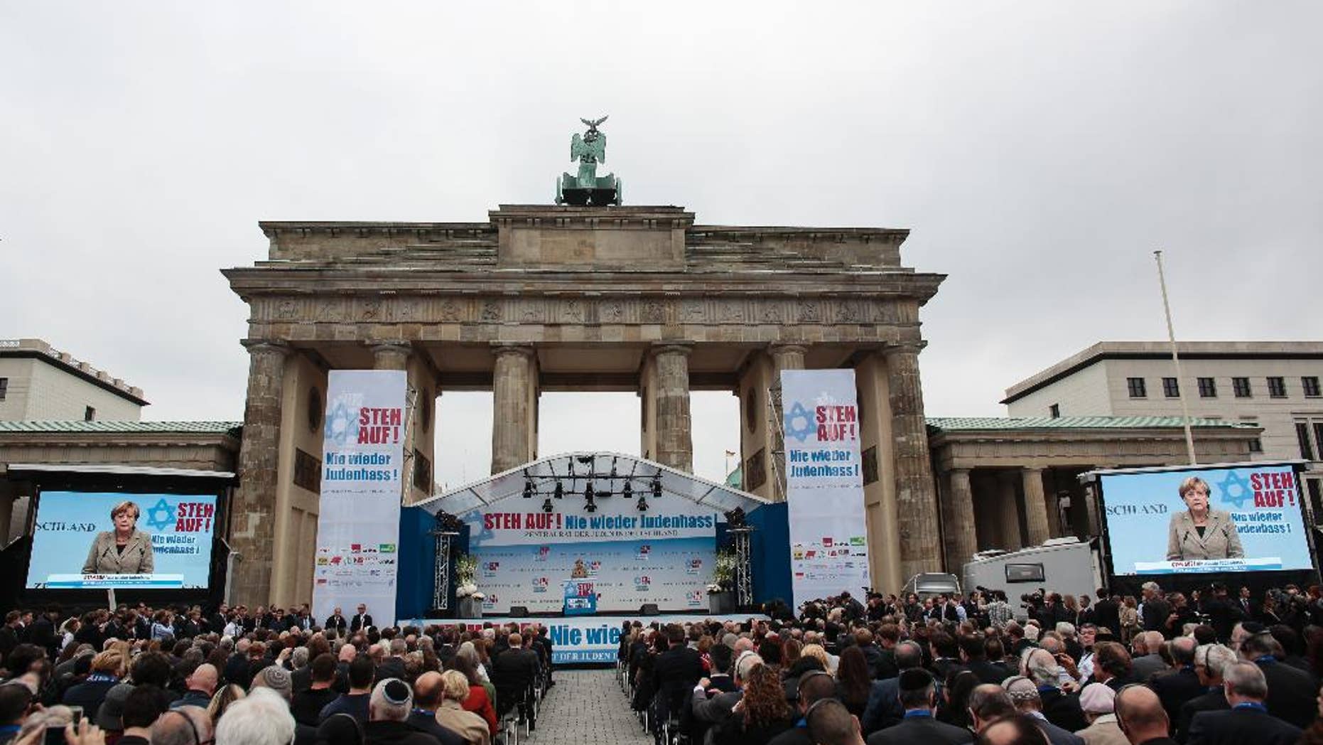 German Chancellor Angela Merkel delivers her speech at a rally against anti-Semitism near the Brandenburg Gate in Berlin, Sunday, Sept. 14, 2014. Thousands of protesters attended the public rally organized by Germany’s Jewish community at the capital’s Brandenburg Gate after tensions over the Gaza conflict spilled over into demonstrations in Europe that saw anti-Jewish slogans and violence. The slogan reads: Stand Up! - Jew hatred - never again!', and the name of the organizer: Central Council of Jews in Germany. (AP Photo/Markus Schreiber)