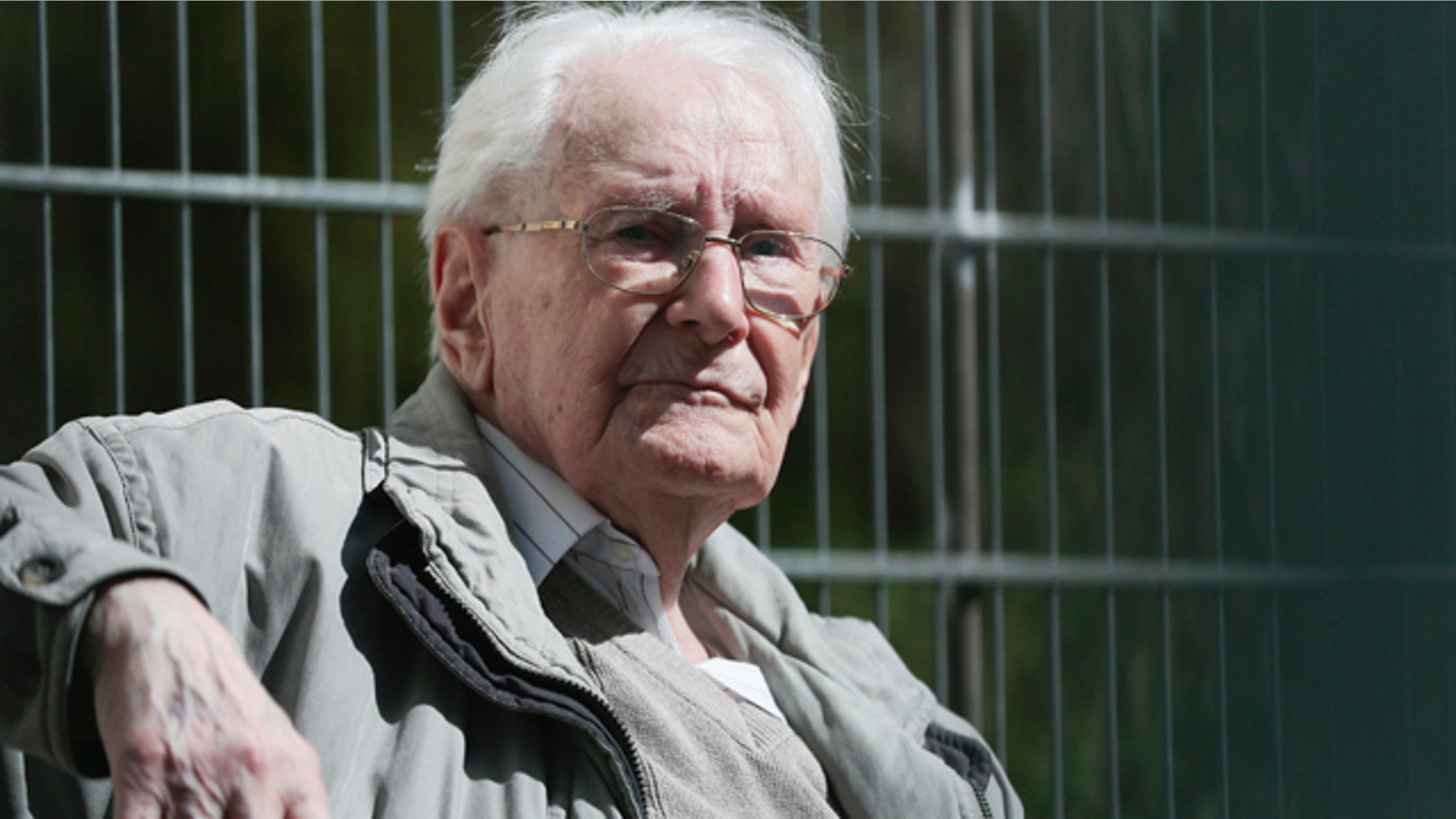 April 21, 2015: Former SS guard Oskar Groening sits in ths sun during the noon break of the trial against him in Lueneburg, northern Germany. Groening, 93, faces 300,000 counts of accessory to murder at the trial, which will test the argument that anyone who served as a guard at a Nazi death camp was complicit in what happened there. (AP Photo/Markus Schreiber)