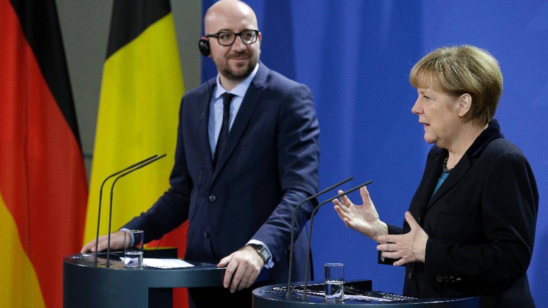 German Chancellor Angela Merkel, right, and the Prime Minister of Belgium, Charles Michel, left, address the media during a joint press conference as part of a meeting at the chancellery in Berlin, Germany, Friday, Nov. 21, 2014. (AP Photo/Michael Sohn)