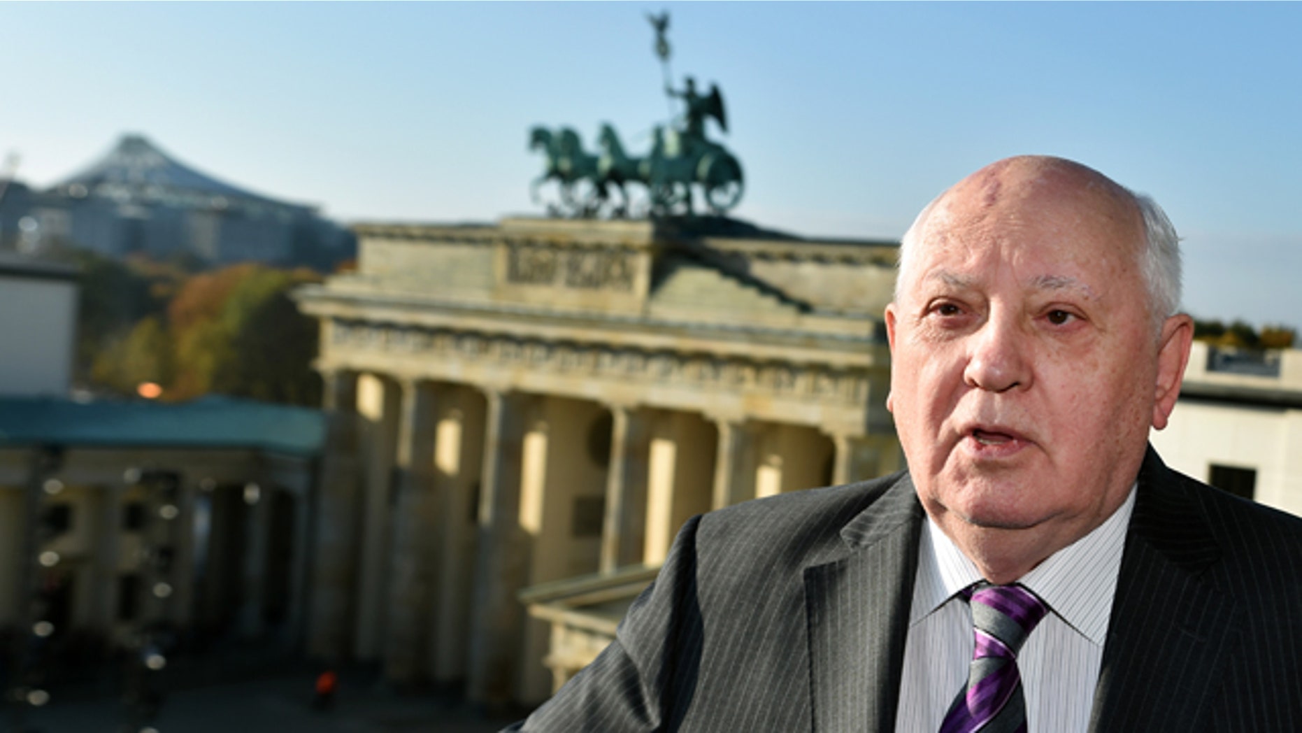 November 8, 2014: Former Soviet Leader Mikhail Gorbachev stands in front of the Brandenburg Gate in Berlin. (AP Photo/dpa, Jens Kalaene)