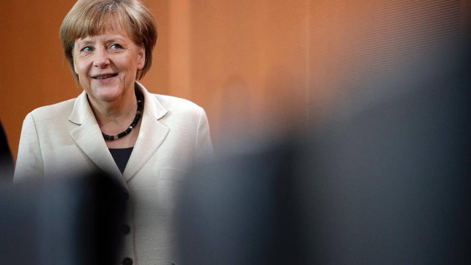 German Chancellor Angela Merkel arrives for the weekly cabinet meeting at the chancellery in Berlin, Germany, Wednesday, May 21, 2014. (AP Photo/Michael Sohn)
