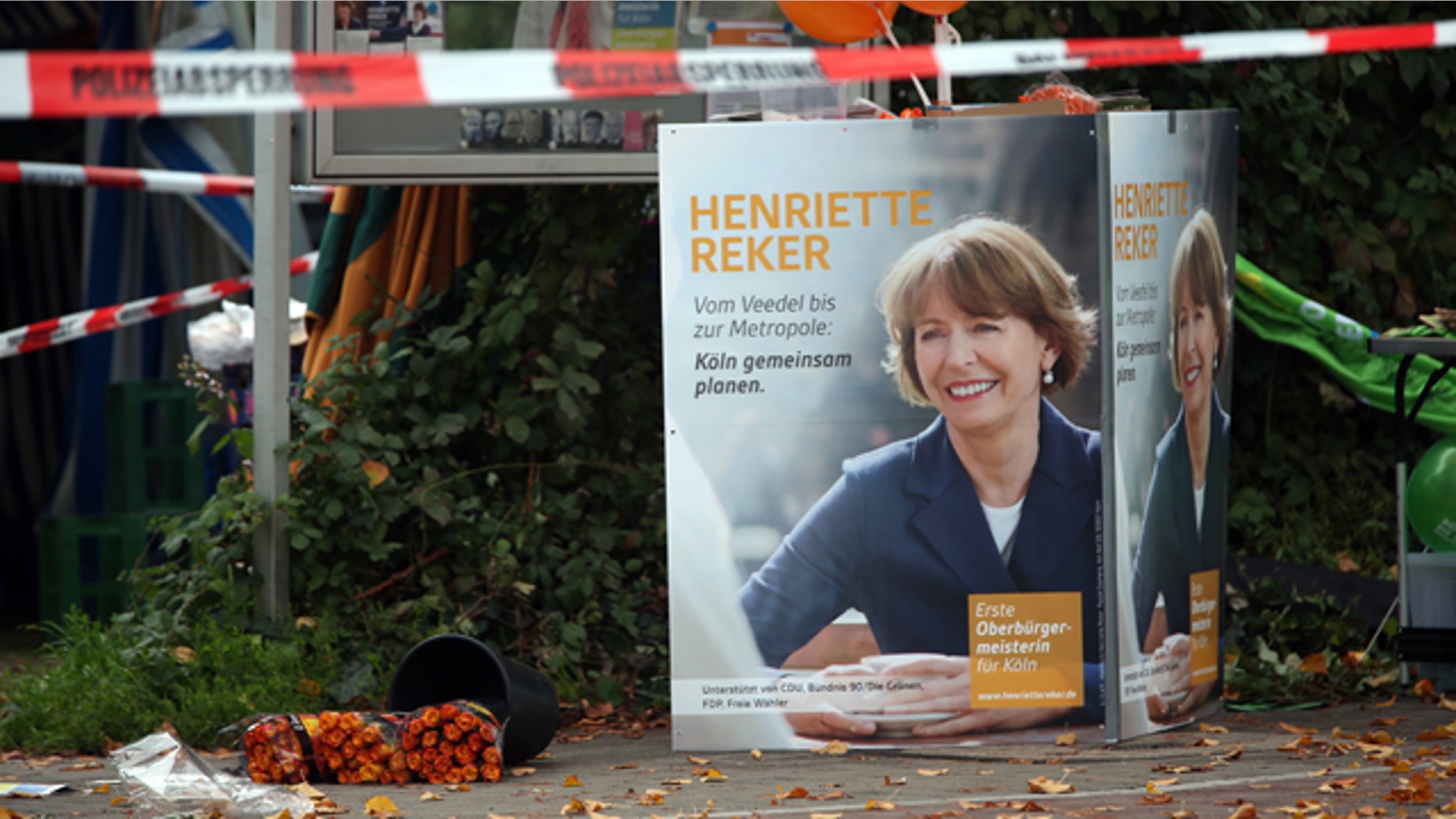 Oct. 17, 2015: Election posters of independent candidate for the mayor of Cologne Henriette Reker stand behind a police barrier in Cologne, Germany. Reker was wounded in a stabbing at this site as she campaigned on Saturday, a day before an election in the western German city. (Oliver Berg/dpa via AP)