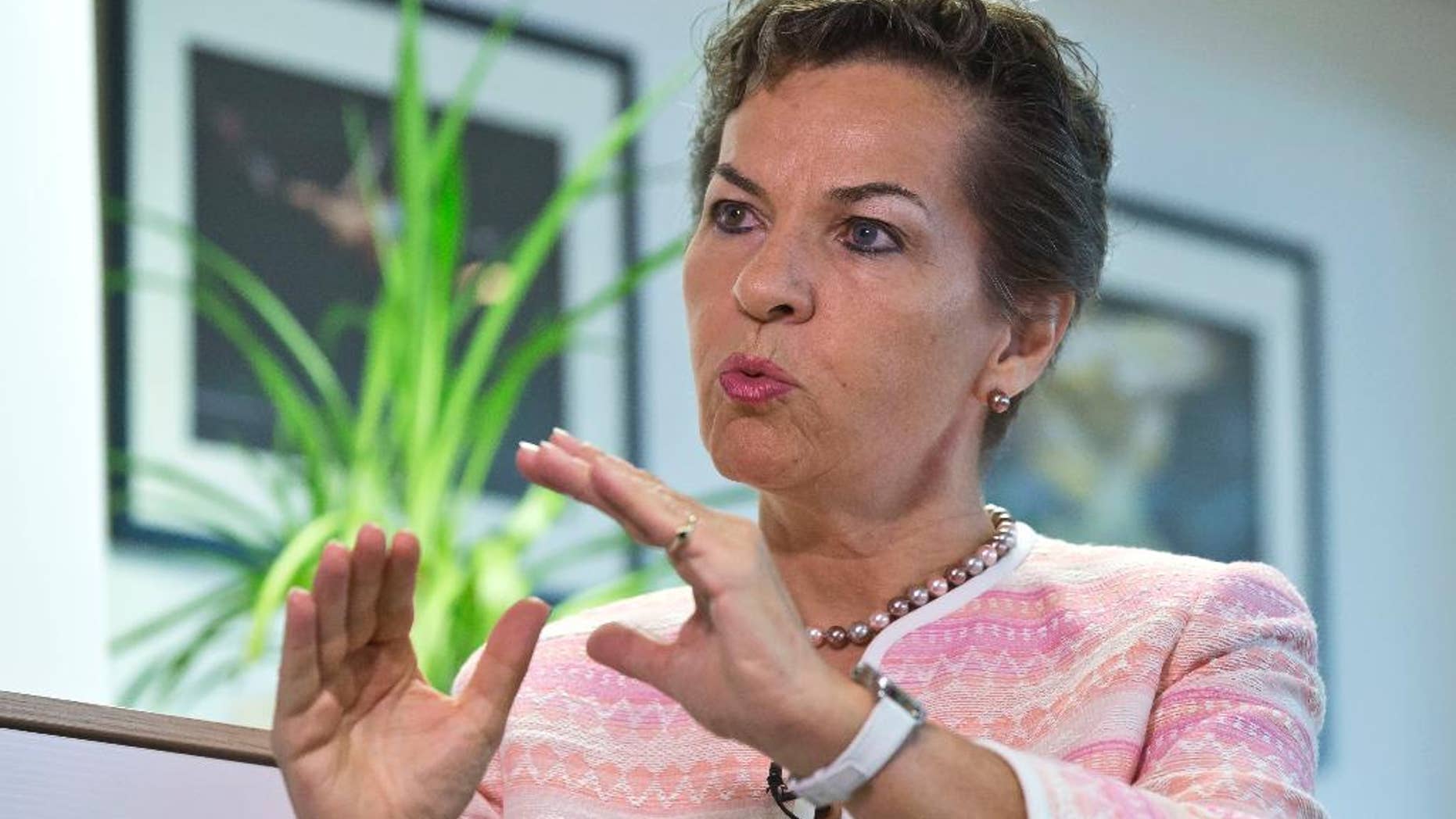 FILE - In this July 22, 2015 file photo United Nations climate chief Christiana Figueres, gestures as she speaks during an interview of the Associated Press in Paris, France. Figueres says Friday, Oct. 30, 2015, emissions-cutting pledges made by governments ahead of a December conference are a good step toward achieving an international global-warming goal, but they aren't yet enough. (AP Photo/Michel Euler, file)