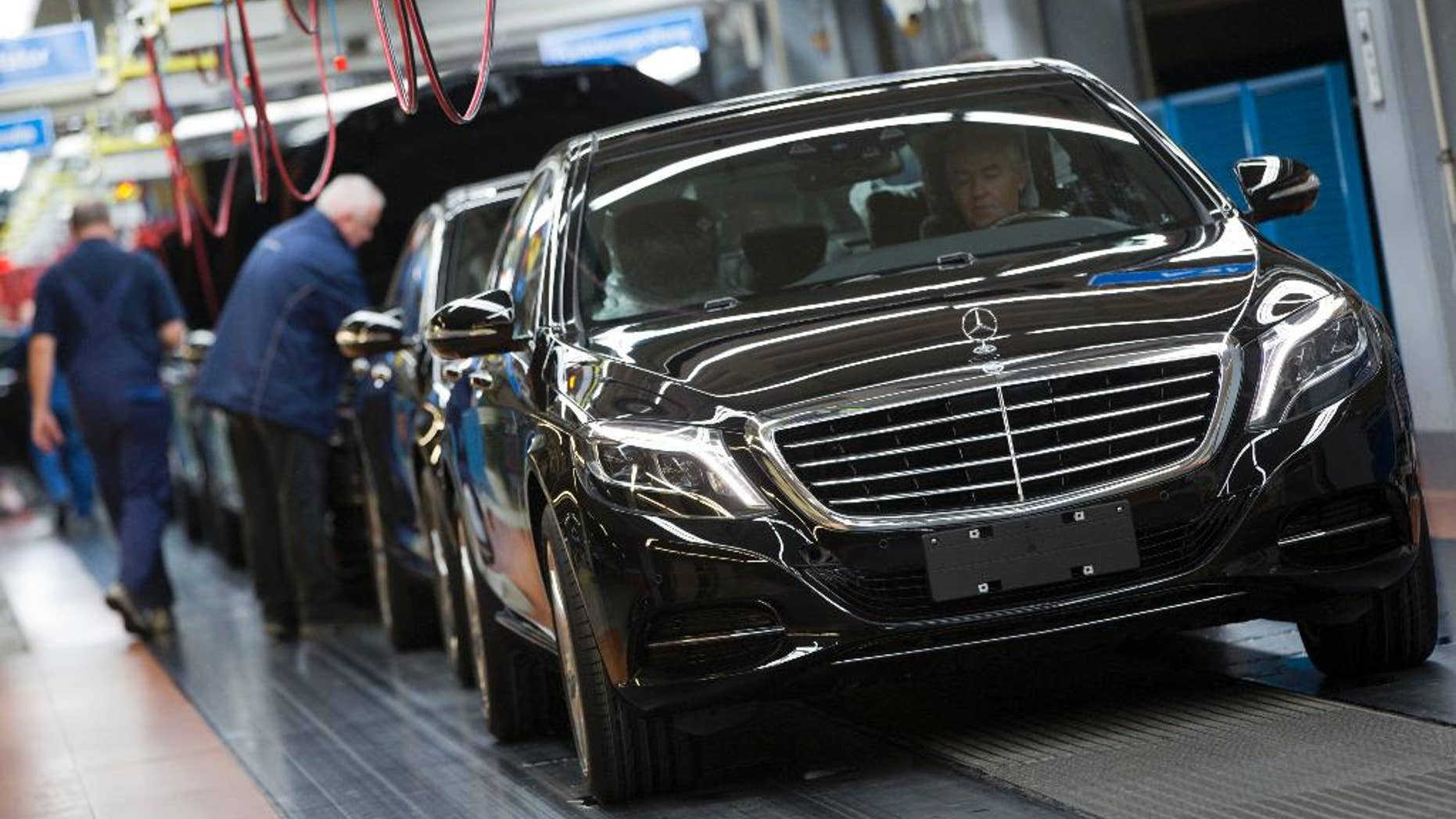 In this Jan. 28, 2015 picture an employee of the Mercedes-Benz AG checks a S-Class model at the plant in Sindelfingen, Germany. Daimler will present its second quarter earning Thursday, July 23, 2015. (AP Photo/Matthias Schrader)