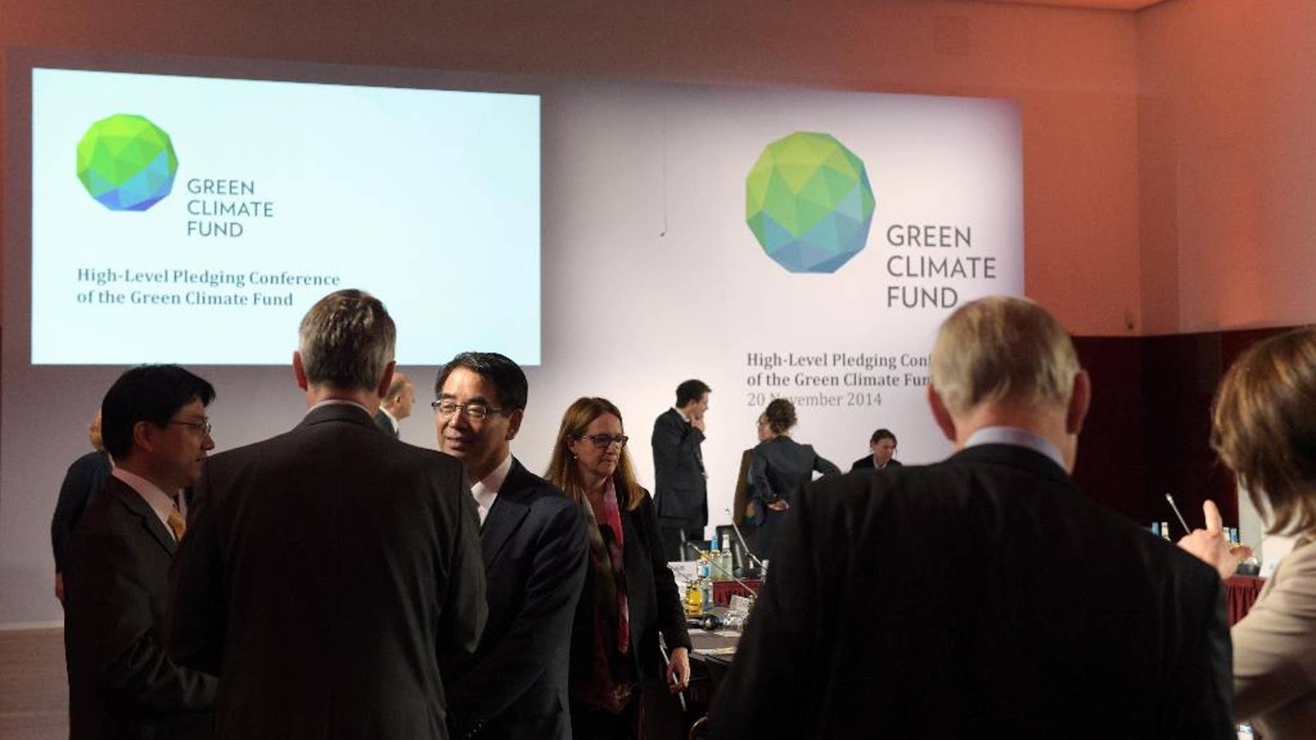 Delegates and participants of the Green Climate Fund talk to each other prior the meeting in Berlin, Germany, Thursday Nov. 20, 2014. A United Nations fund that will help poor countries tackle climate change has fallen short for now of its target of collecting US $10 billion, officials said Thursday. Some 30 countries meeting in Berlin pledged a total of $9.3 billion toward the Green Climate Fund. (AP Photo/dpa,Rainer Jensen)