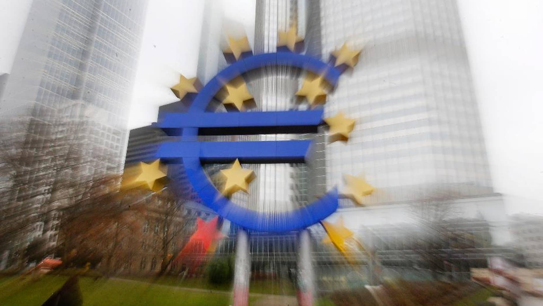 In this zoomed picture the Euro sculpture stands in front of the old European Central Bank in Frankfurt, Germany, Monday, Jan. 26, 2015. The euro wobbled Monday after Greece's anti-austerity opposition party won a big victory in national elections, renewing fears the European common currency bloc could unravel.(AP Photo/Michael Probst)