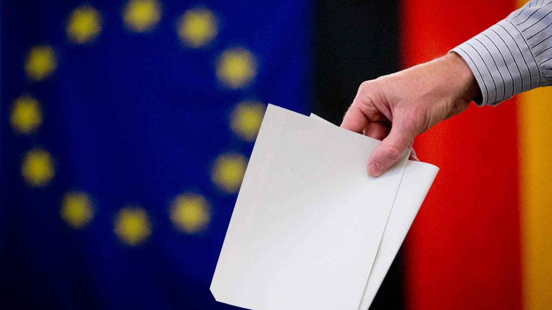 A man casts his ballot for the European elections and a local referendum on the Tempelhof field in a polling station in Berlin, Germany, on Sunday, May 25, 2014. (AP Photo, dpa,Kay Nietfeld)