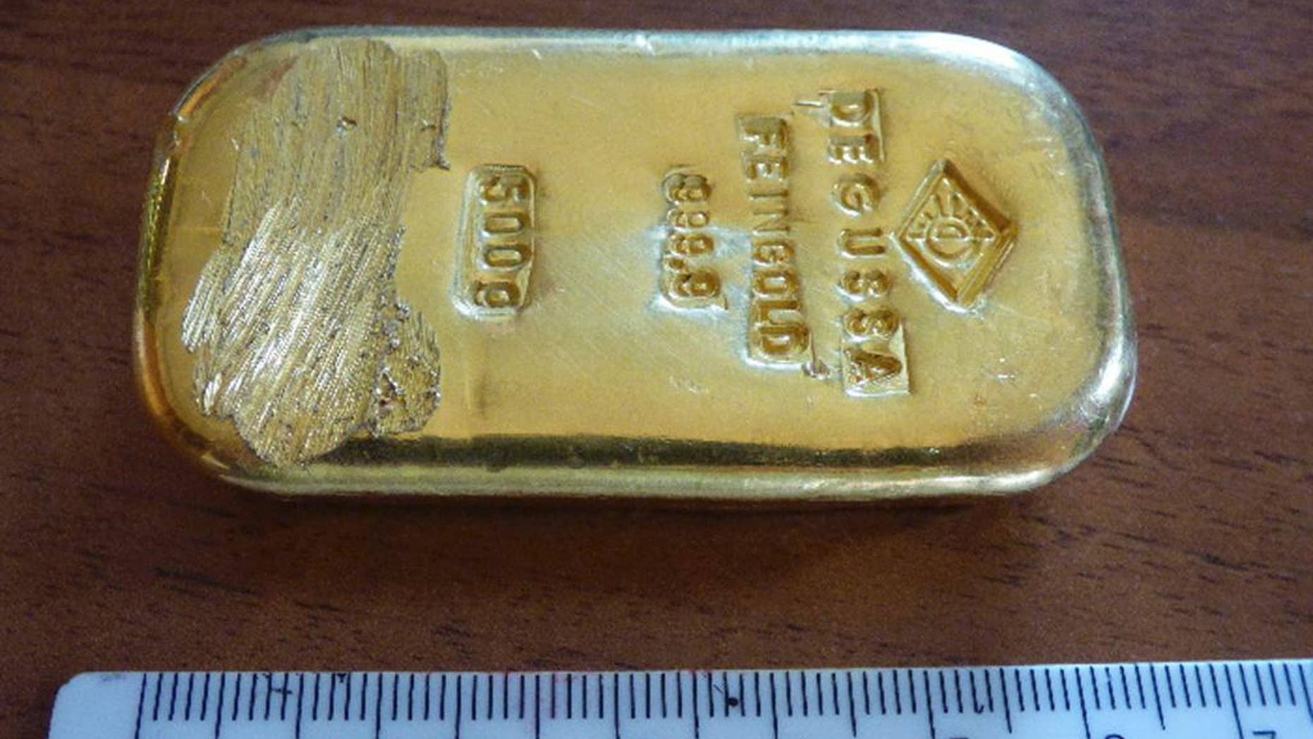 The photo released by the police in Rosenheim on Aug. 12, 2015 shows a gold bar that was found by a teenager when swimming in a lake near Berchtesgaden. Police said in a statement that they still try to find out from where the 500g (17.6-ounce) bar came. (Polizeipraesidium Oberbayern Sued via AP)