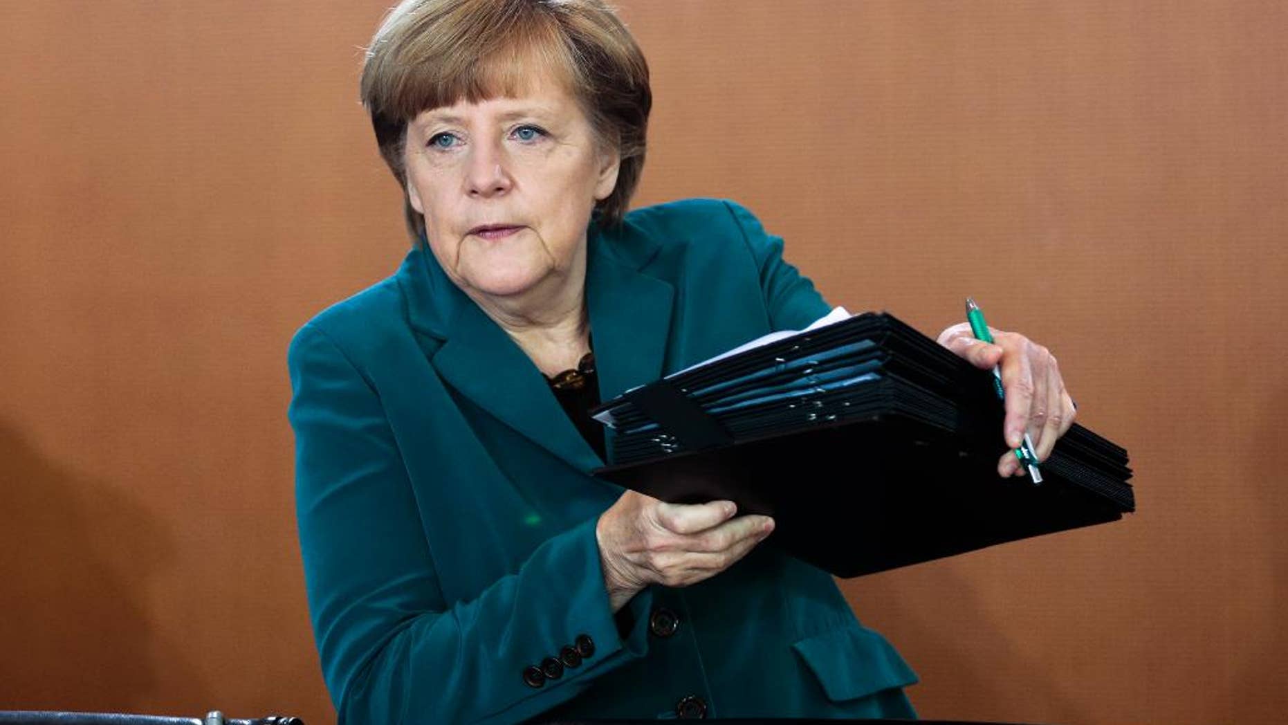 German Chancellor Angela Merkel arrives at the weekly cabinet meeting in Berlin, Germany, Wednesday, April 30, 2014. (AP Photo/Markus Schreiber)