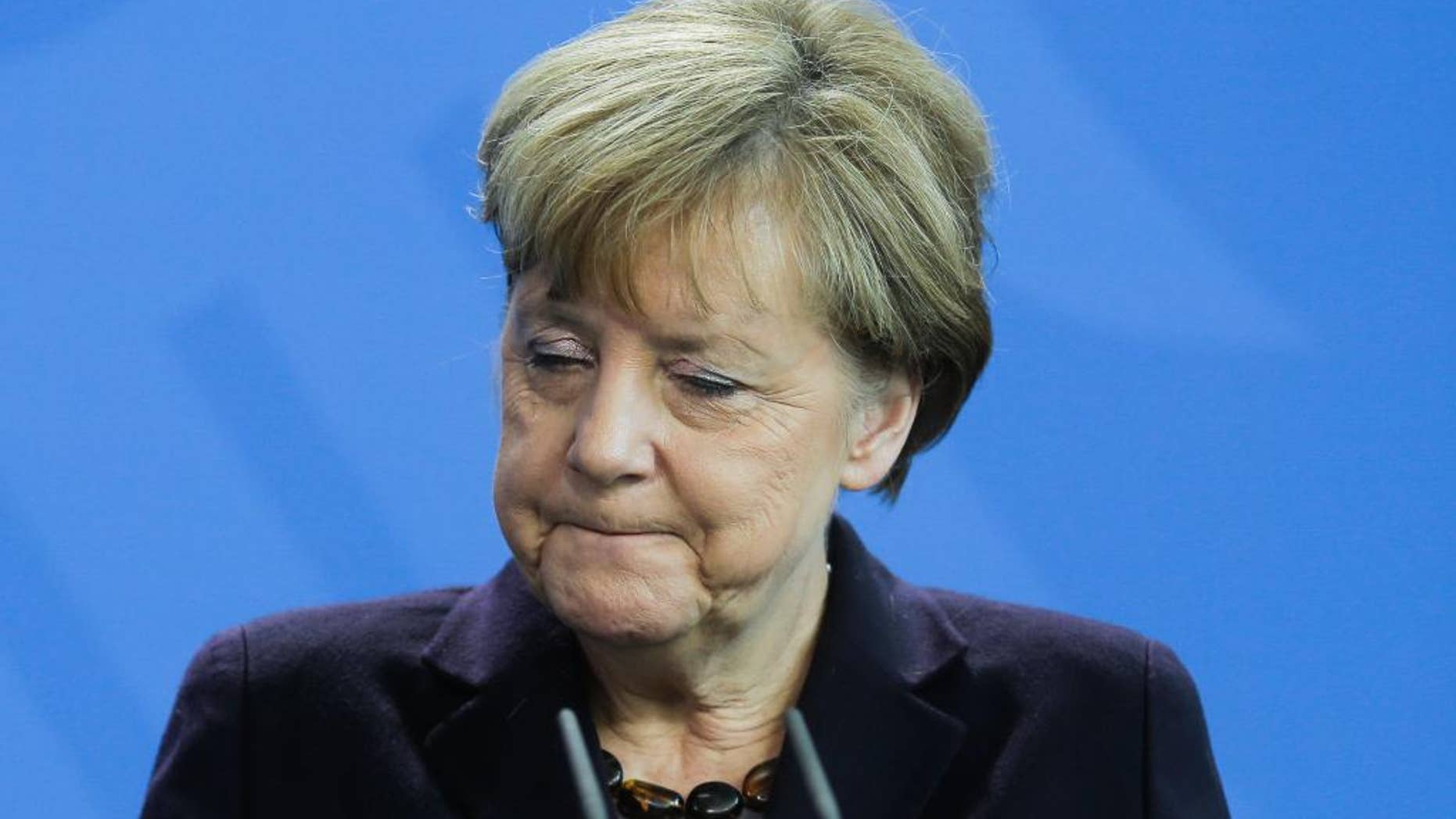 German Chancellor Angela Merkel answers questions during a news conference with the President of Honduras Juan Orlando Hernandez, at the chancellery, in Berlin, Tuesday, Oct. 27, 2015. (AP Photo/Markus Schreiber)