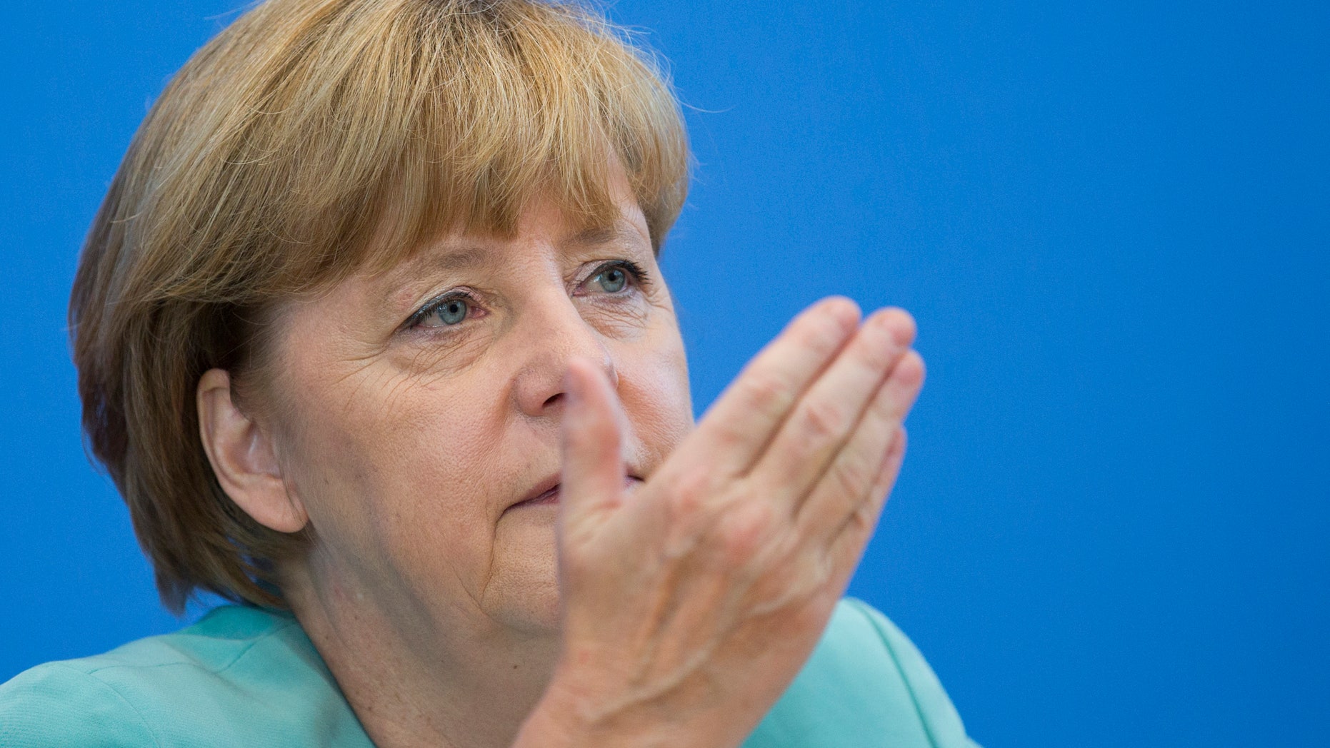 German Chancellor Angela Merkel gestures during a press conference in Berlin, Germany, Friday, July 19, 2013. Chancellor Angela Merkel is acknowledging Germans have been unsettled by allegations of widespread U.S. surveillance though she insists patience is needed as officials seek answers from Washington. Merkel faced a barrage of questions about the National Security Agency's activities at a news conference Friday following a week in which her opponents have asserted she's doing too little to confront the U.S. and protect Germans' data. Germany holds elections Sept. 22 in which Merkel seeks a third term. (AP Photo/Gero Breloer)