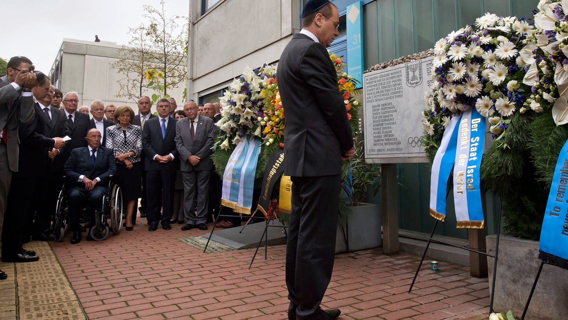 Israel's deputy Prime Minister Silvan Shalom, right, stands in front of wreaths at a memorial at the former accommodation building of the Israeli Olympic team in Munich, southern Germany, Wednesday, Sept. 5, 2012, during a commemoration ceremony for the assassination victims of the Olympic games in Munich in 1972. 17 people died in a failed liberation attempt of Israeli hostages, eleven of them of Israel's Olympic team, five terrorists and a German police officer. (AP Photo/dapd, Joerg Koch)