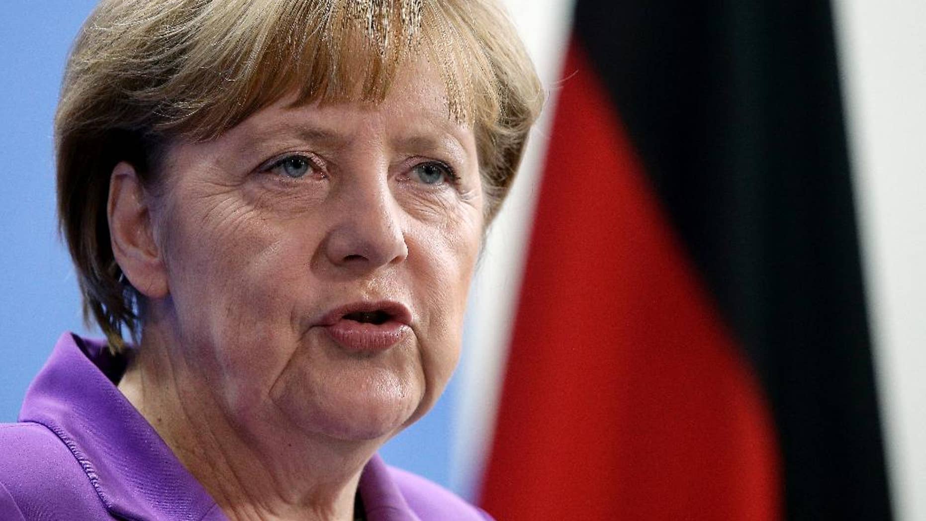 German Chancellor Angela Merkel addresses the media during a joint press conference as part of a meeting with the Prime Minister of Poland, Ewa Kopacz, at the chancellery in Berlin, Germany, Thursday, Oct. 9, 2014. (AP Photo/Michael Sohn)