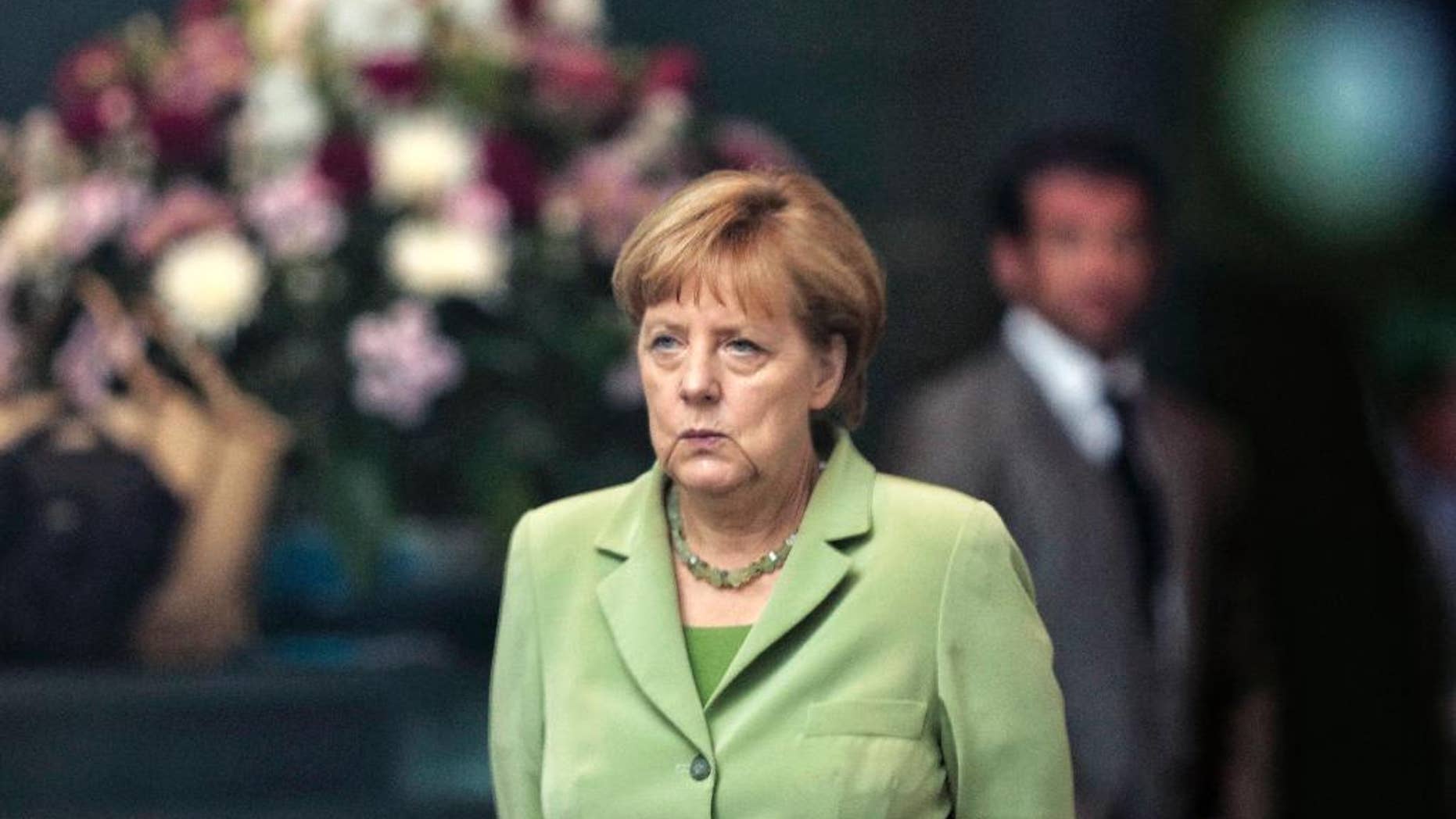 German Chancellor Angela Merkel arrives for the welcoming ceremony of the Prime Minister of Serbia Aleksandar Vucic for talks at the chancellery in Berlin, Wednesday, June 11, 2014. (AP Photo/Markus Schreiber)