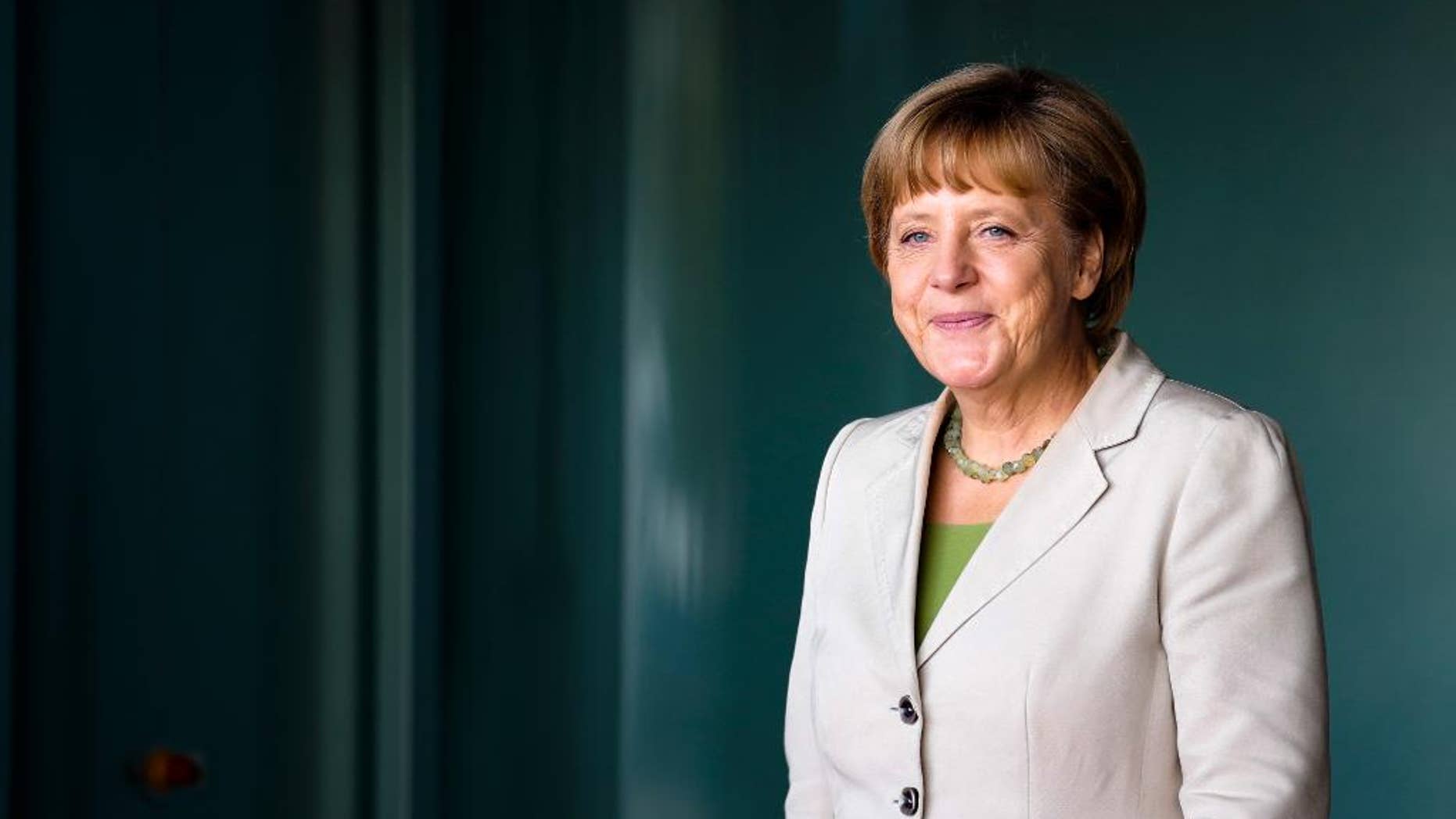 German Chancellor Angela Merkel waits for the arrival of the participants at the 'West Balkan Conference' at the chancellery in Berlin, Thursday, Aug. 28, 2014. Merkel invited to the conference to support the economic and political situation in the South-East European region. (AP Photo/Markus Schreiber, Pool)