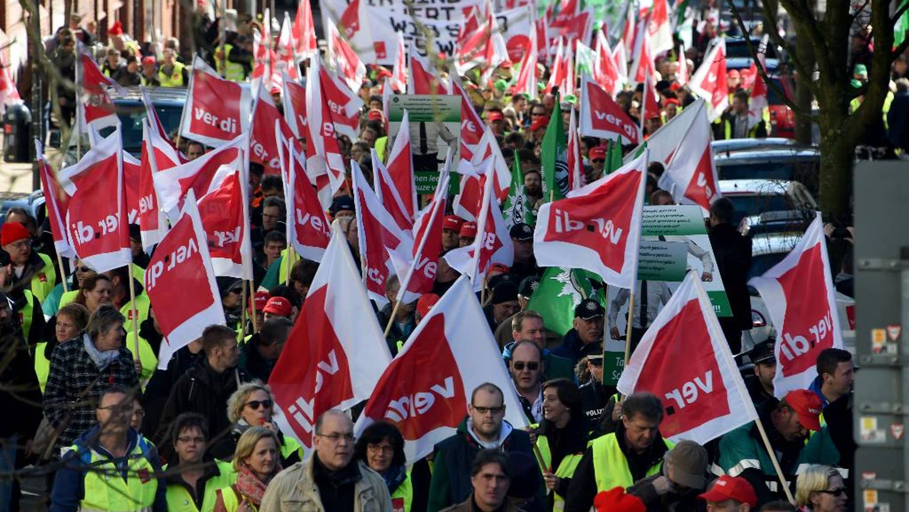 German public service workers join al rally in a bid to receive higher wages and preserve pension benefits in Kiel, northern Germany, Wednesday, March 11, 2015. The ver.di union said teachers and other public employees including police and firefighters walked off the job in multiple states in Germany. (AP Photo/dpa, Carsten Rehder)